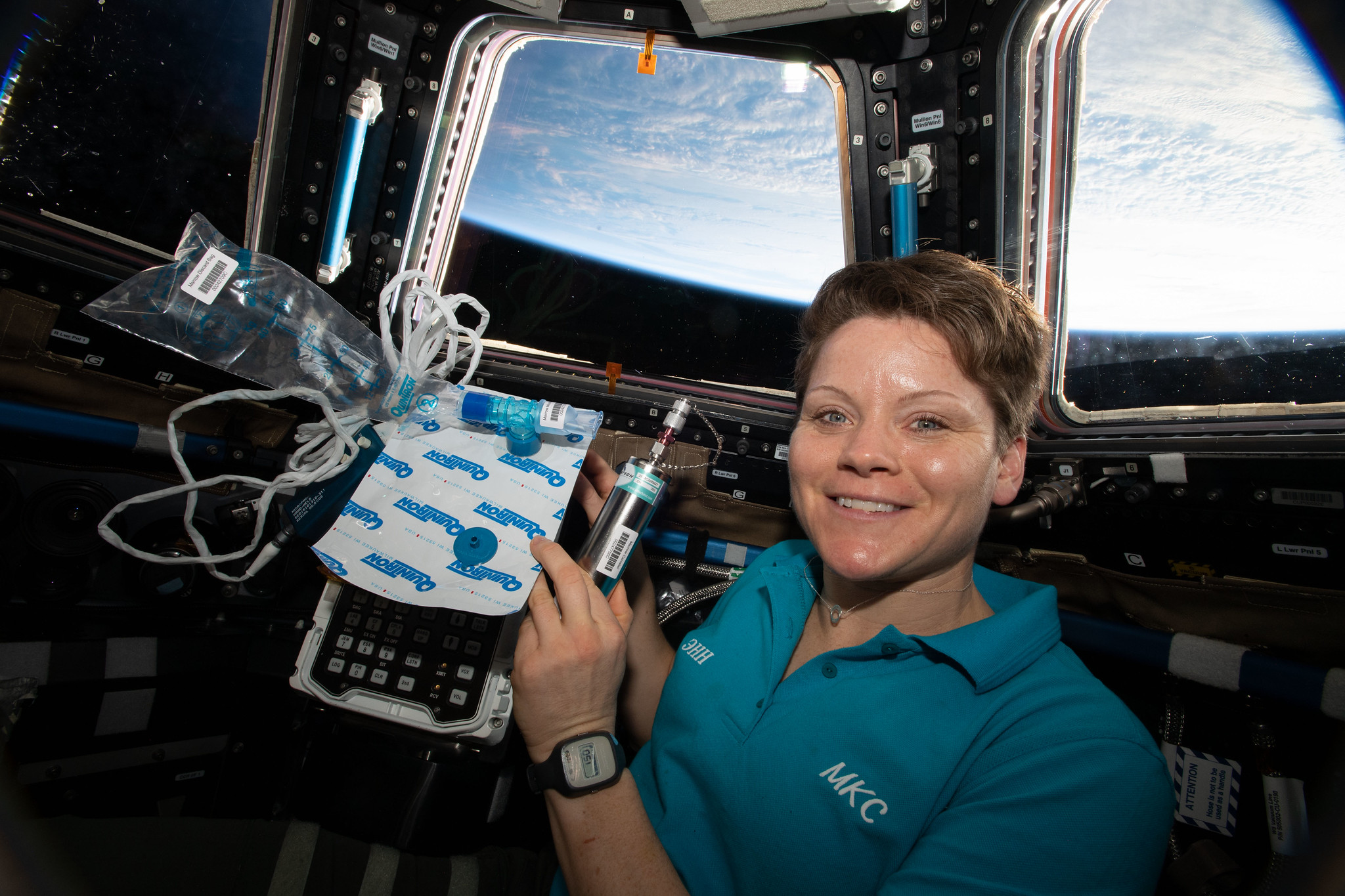Expedition 58 Flight Engineer Anne McClain of NASA is pictured in the cupola holding biomedical gear for the Marrow experiment. 