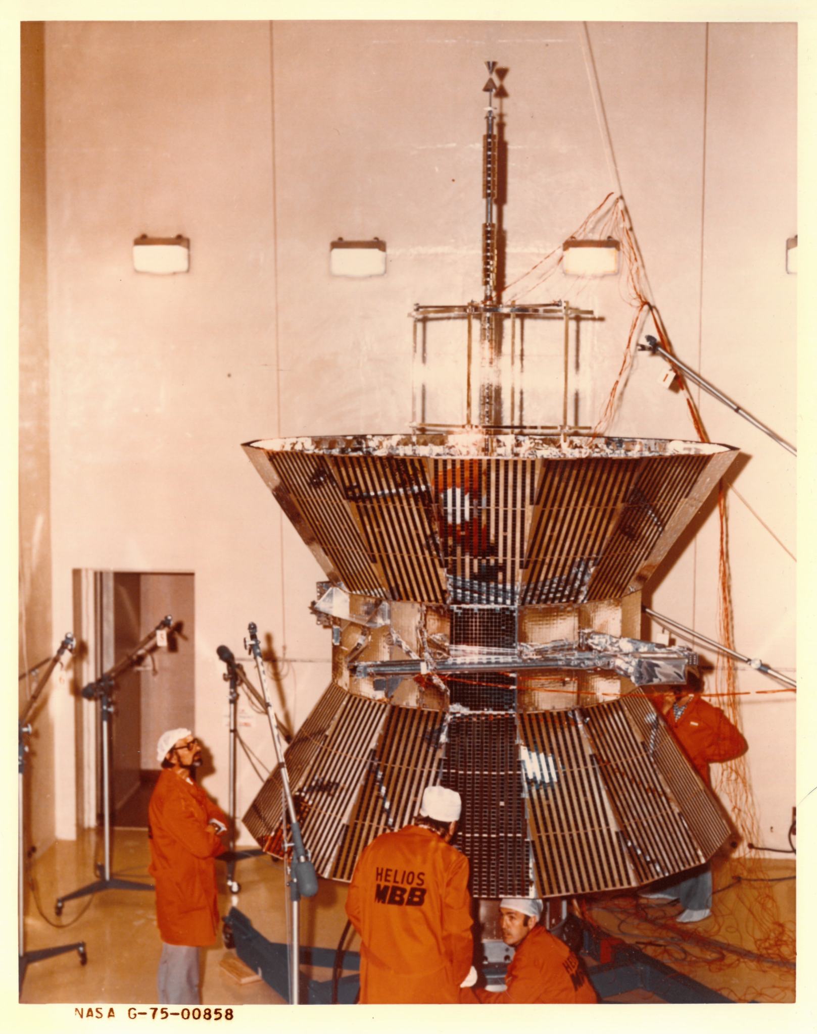 Four engineers inspect the Helios 2 spacecraft. 