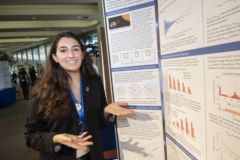 Ana Humphrey standing in front of a poster with various charts and text explaining her research