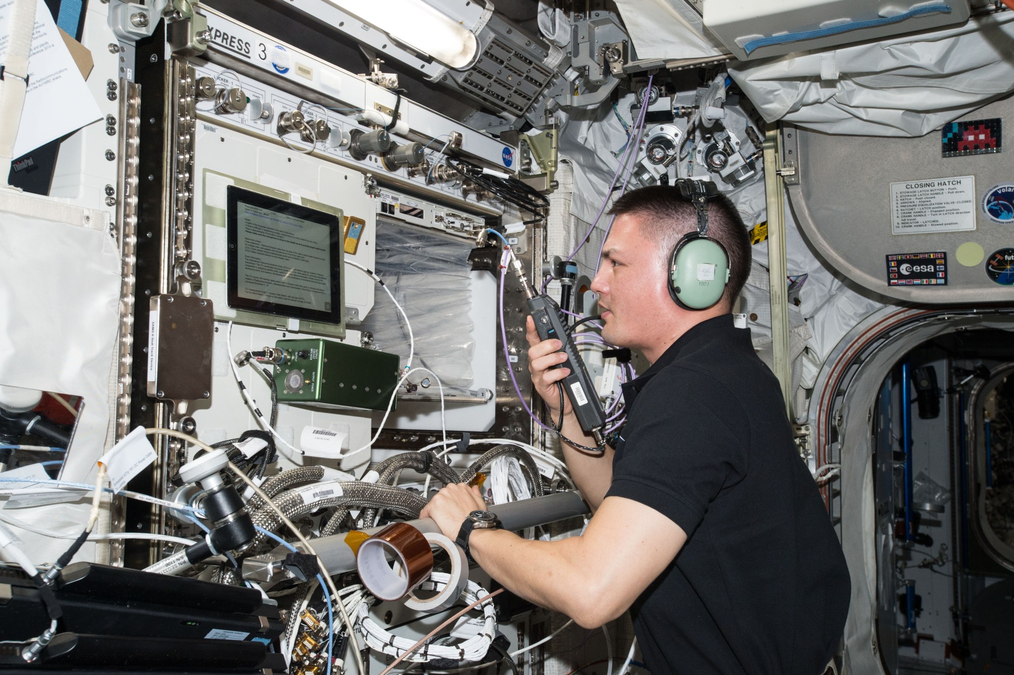 Astronaut Kjell Lindgren uses a HAM radio to speak with operators down on Earth