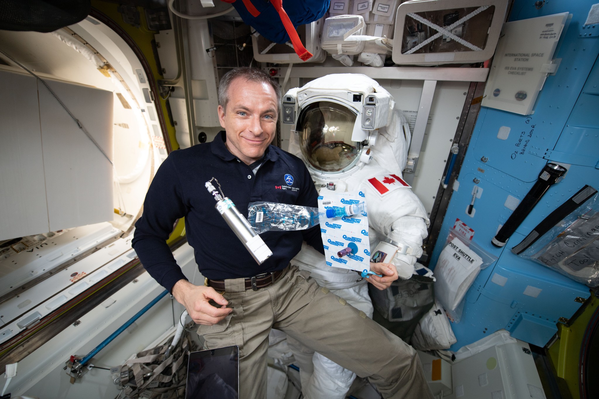 View of Expedition 58 flight engineer (FE) David Saint-Jacques collecting breath, ambient air, and blood samples