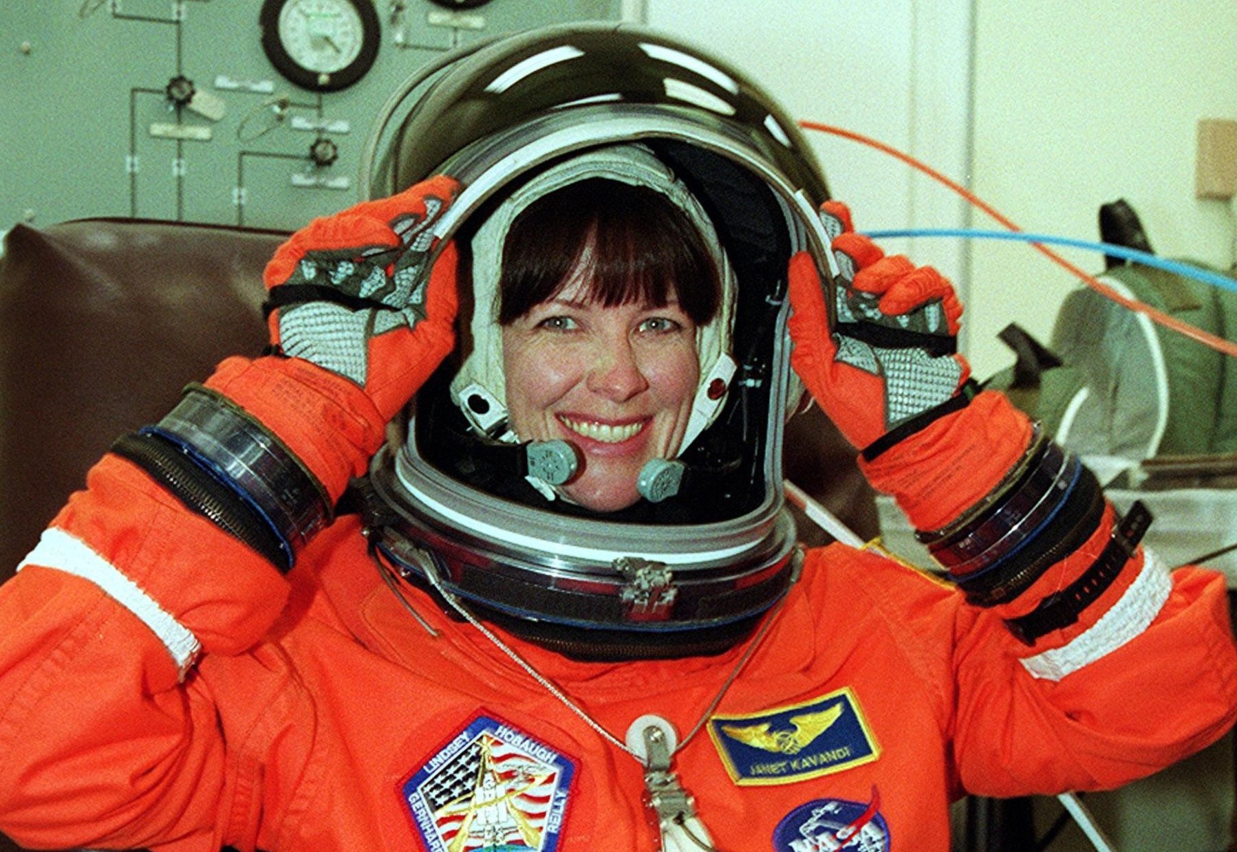 STS-104 Mission Specialist Janet Lynn Kavandi adjusts her helmet as she dons her launch and entry suit.