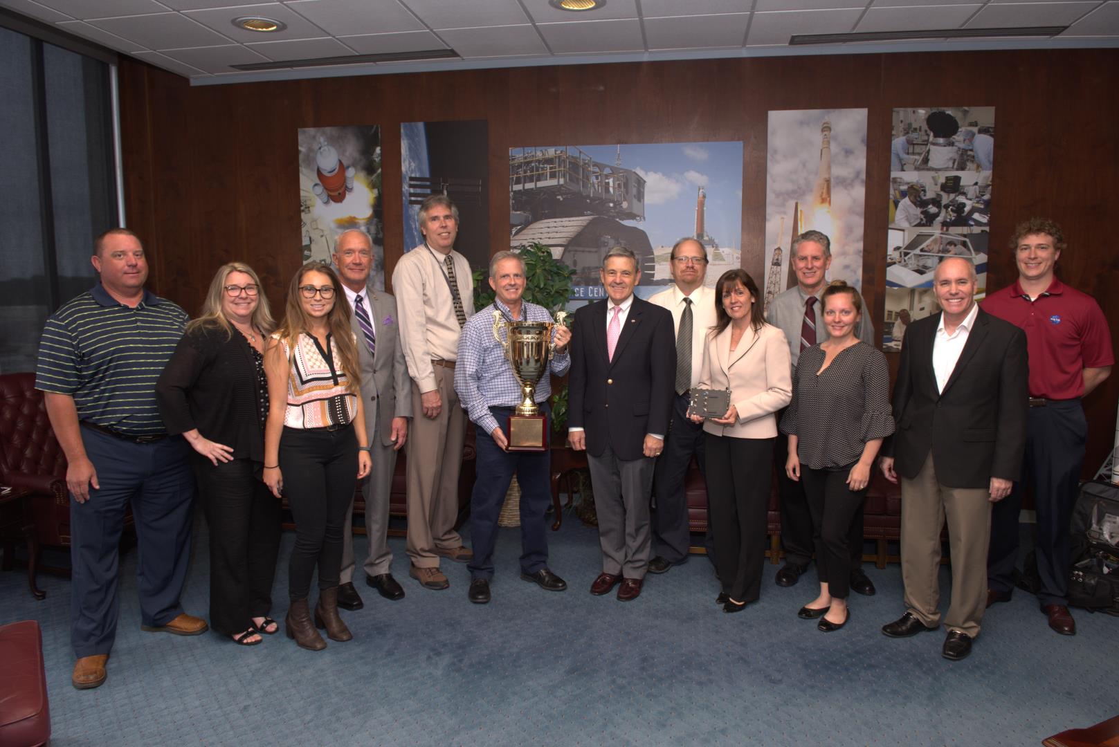 Kennedy Space Center Director Bob Cabana stands among individuals who were recognized from NASA's Technology Transfer Office 