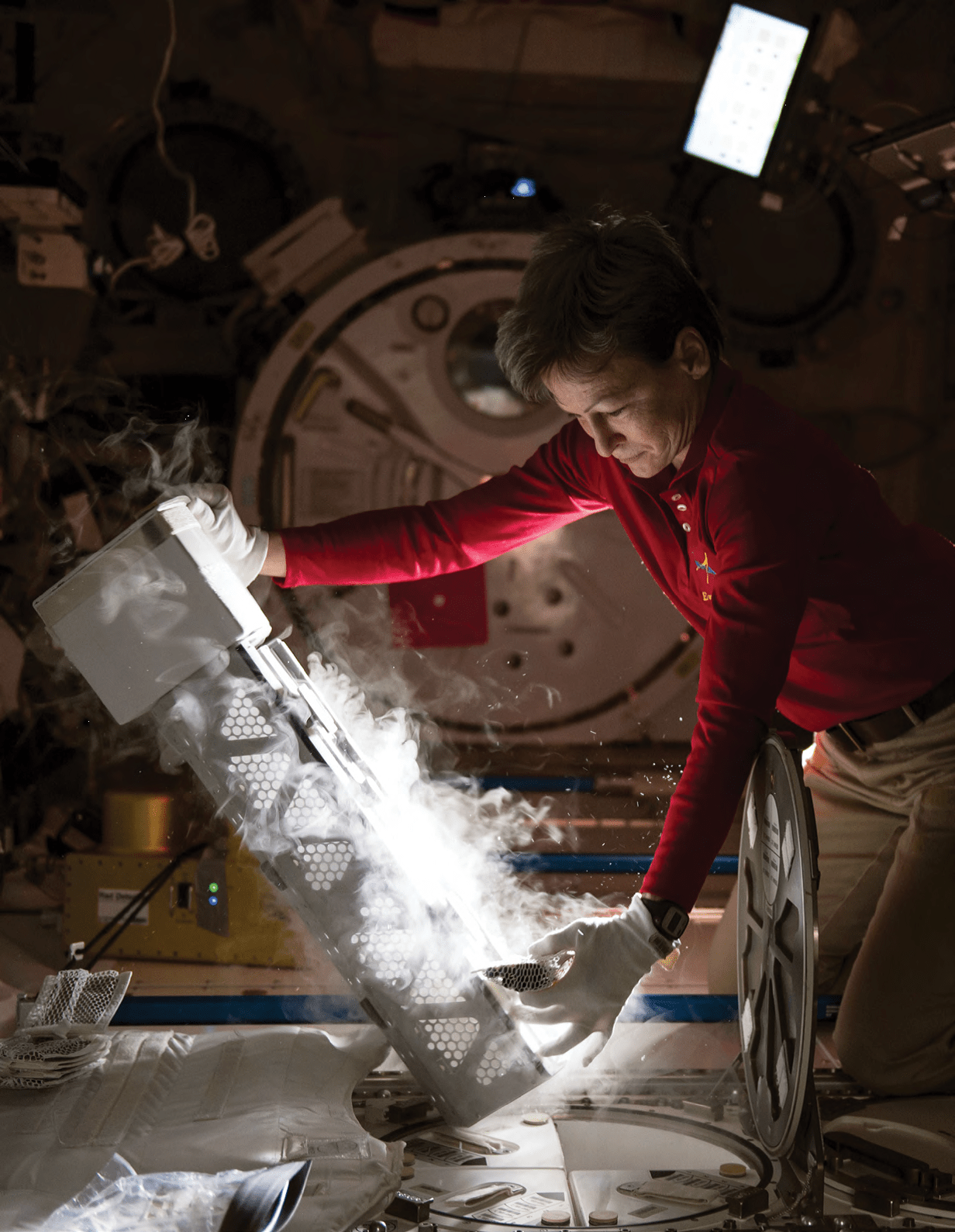 Astronaut Peggy Whitson with the Minus Eighty Laboratory Freezer