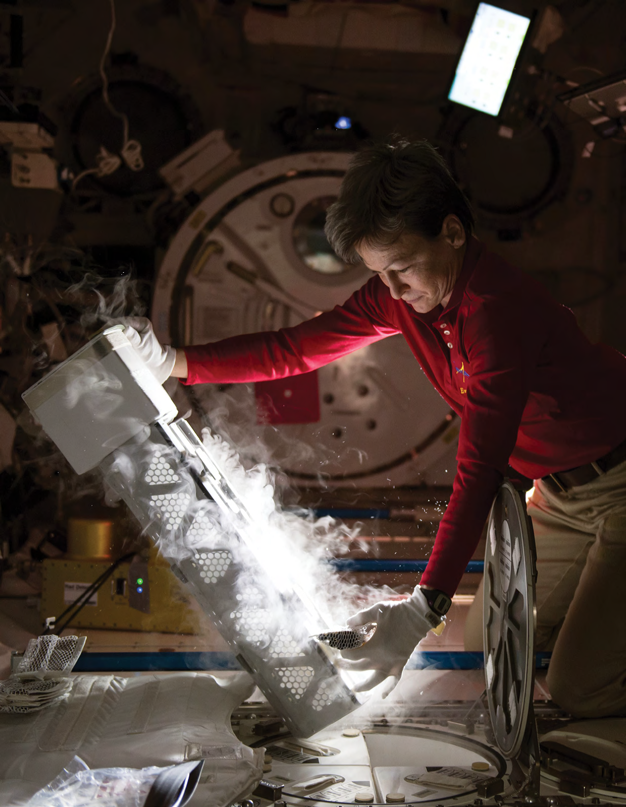 Astronaut Peggy Whitson with the Minus Eighty Laboratory Freezer