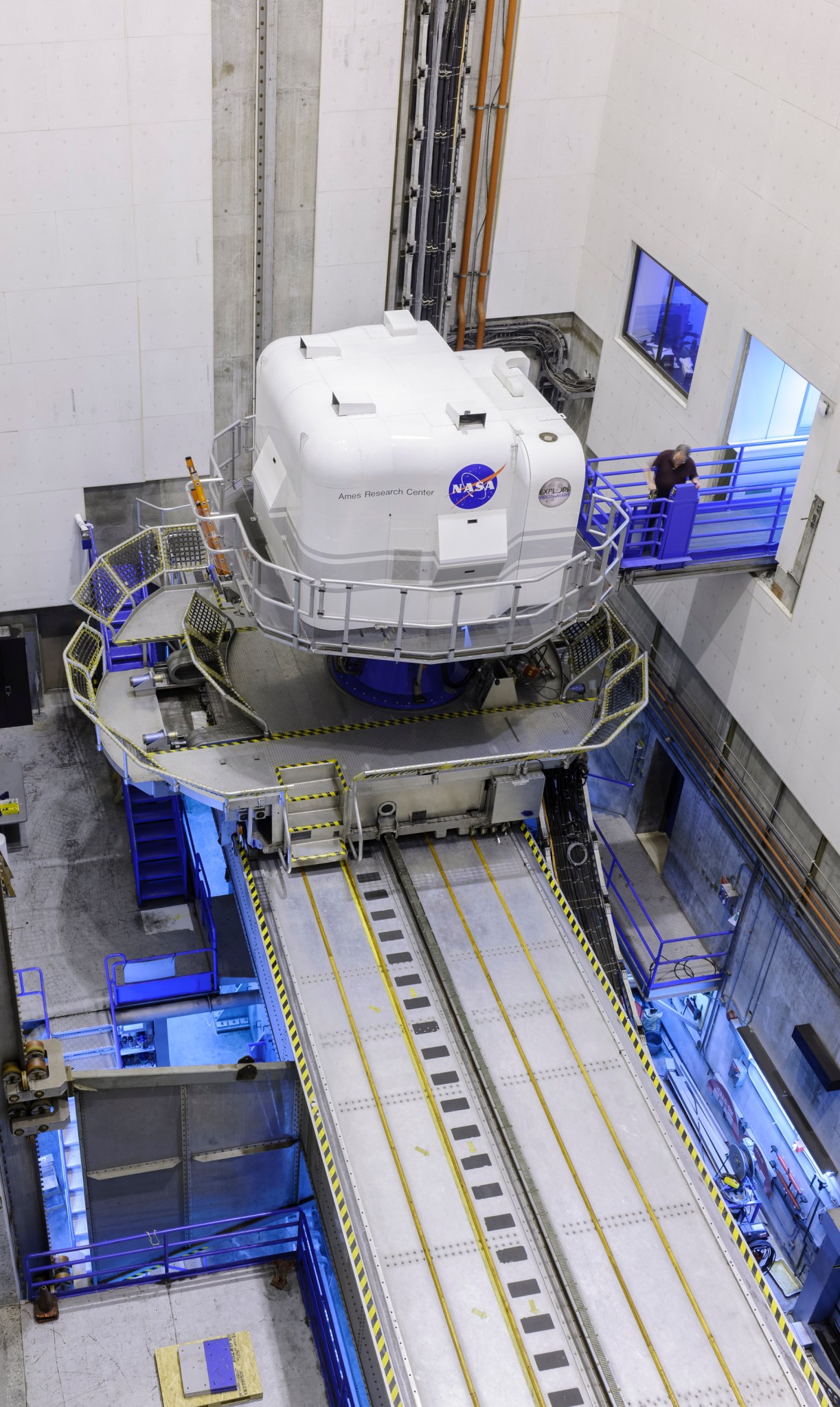 The Vertical Motion Simulator facility, seen from above. The white cab sits on a motion platform.