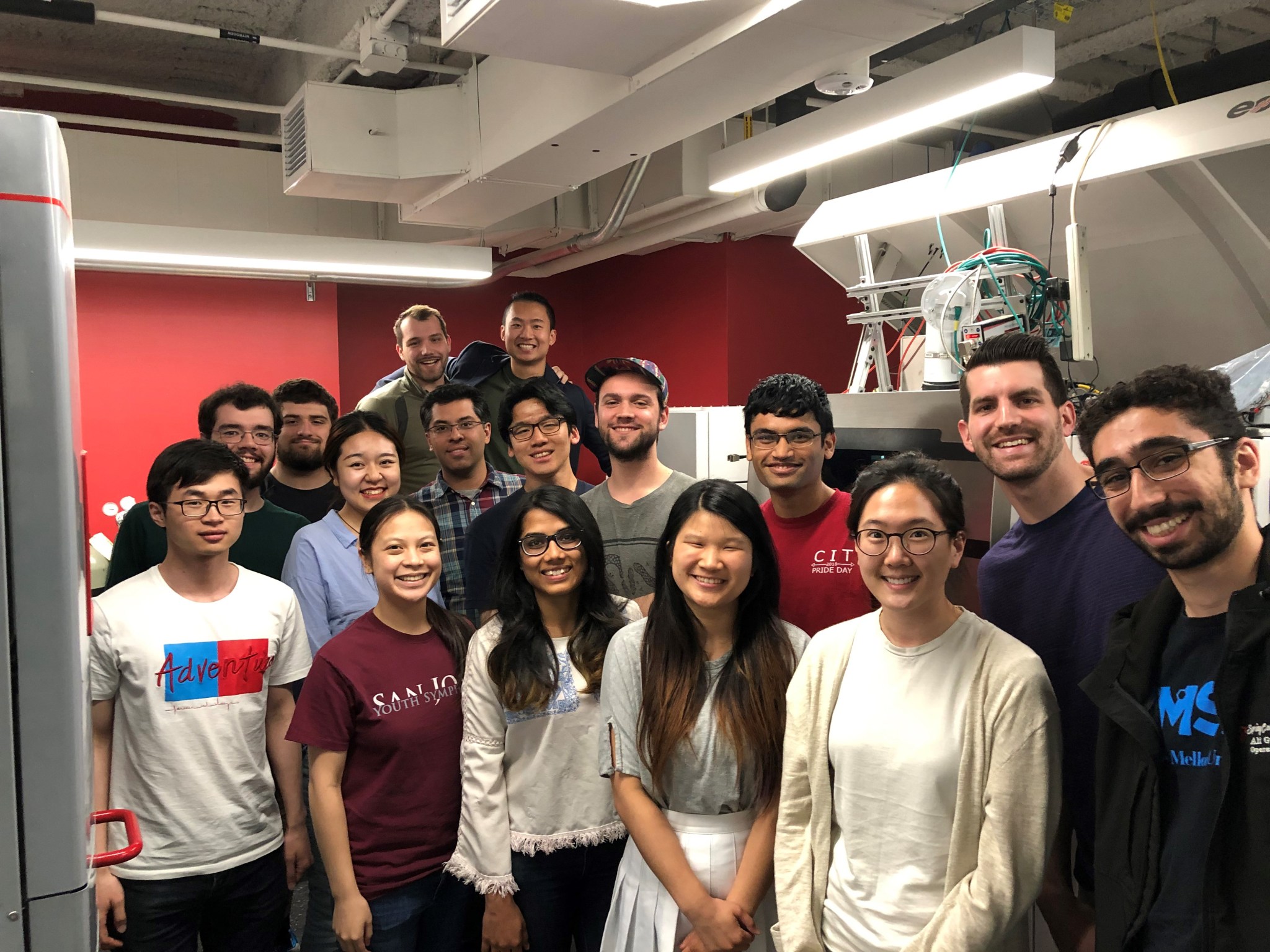 Group photo of students from Carnegie Mellon University standing in front of a 3D printer.