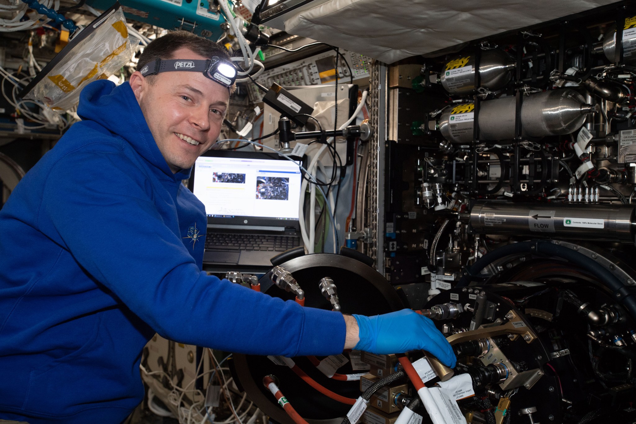 Expedition 59 Flight Engineer Nick Hague performs maintenance on the Advanced Combustion via Microgravity Experiments Chamber