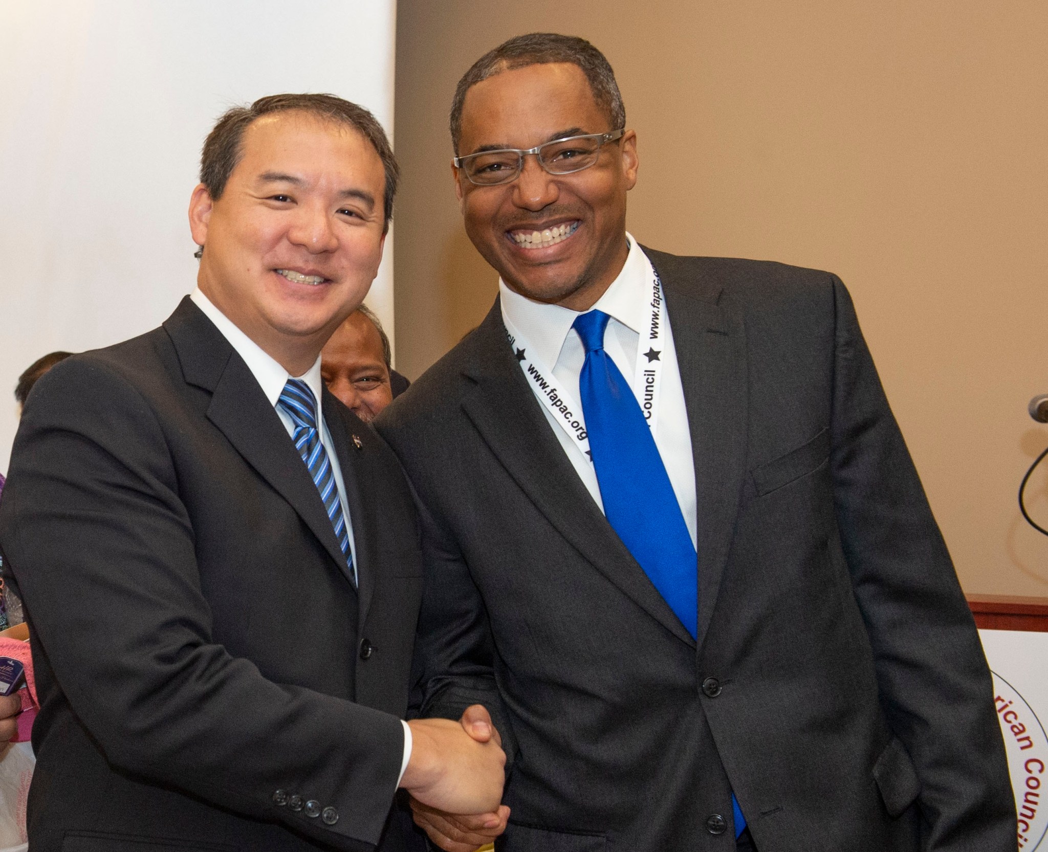 Steve Shih is greeted after his opening address by Melvin McKinstry.