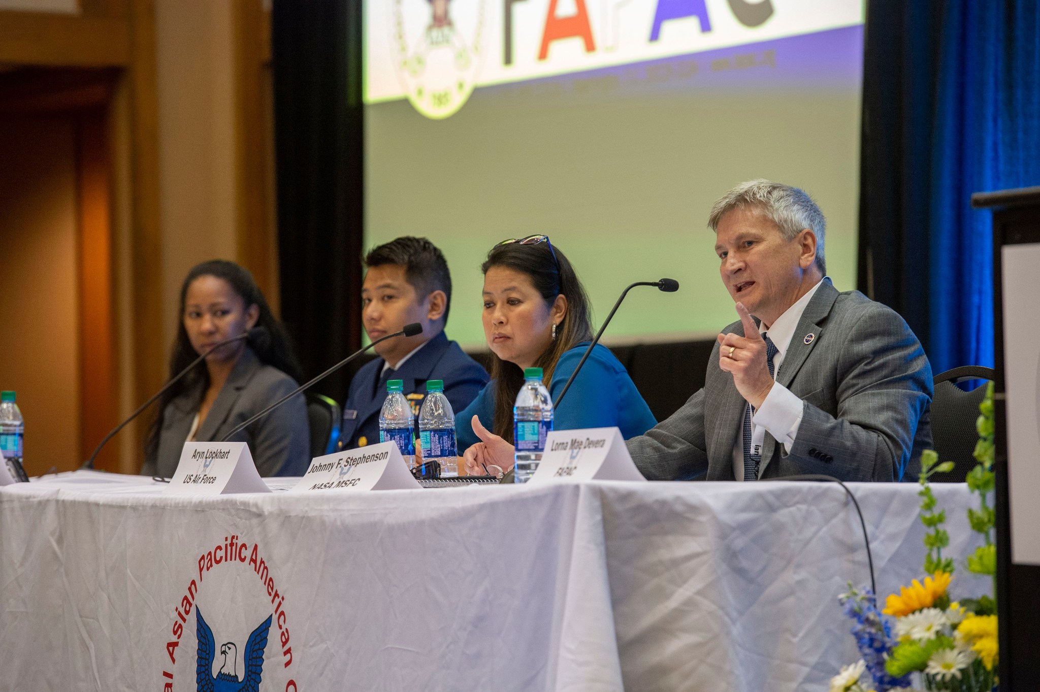 Johnny Stephenson, right, takes part in a May 16 FAPAC panel discussing leadership tactics and diversity in the government.