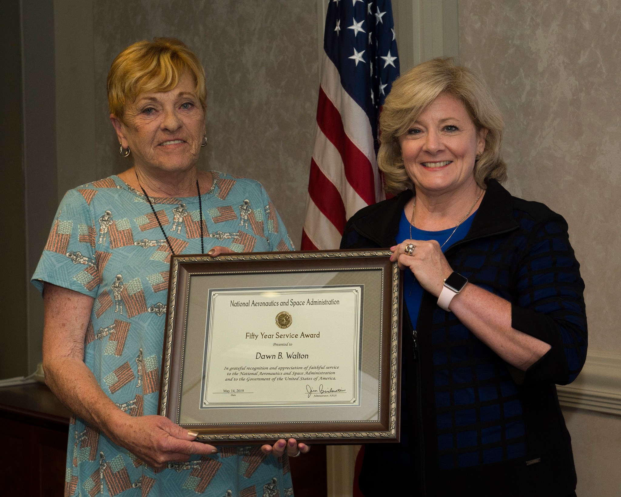 Dawn Walton, left, accepts a 50-year service award presented by Jody Singer.