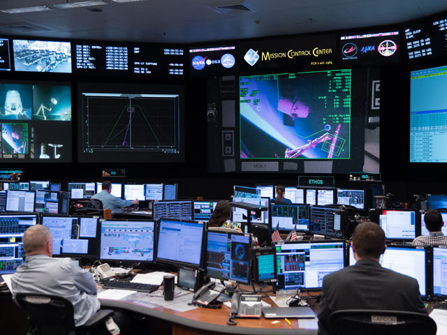 At the Mission Control Center in Houston, Expedition 59 flight controllers monitor the capture and berthing of the SpaceX Dragon cargo craft to the Harmony module of the International Space Station on May 6. Image Credit: NASA/Josh Valcarcel
