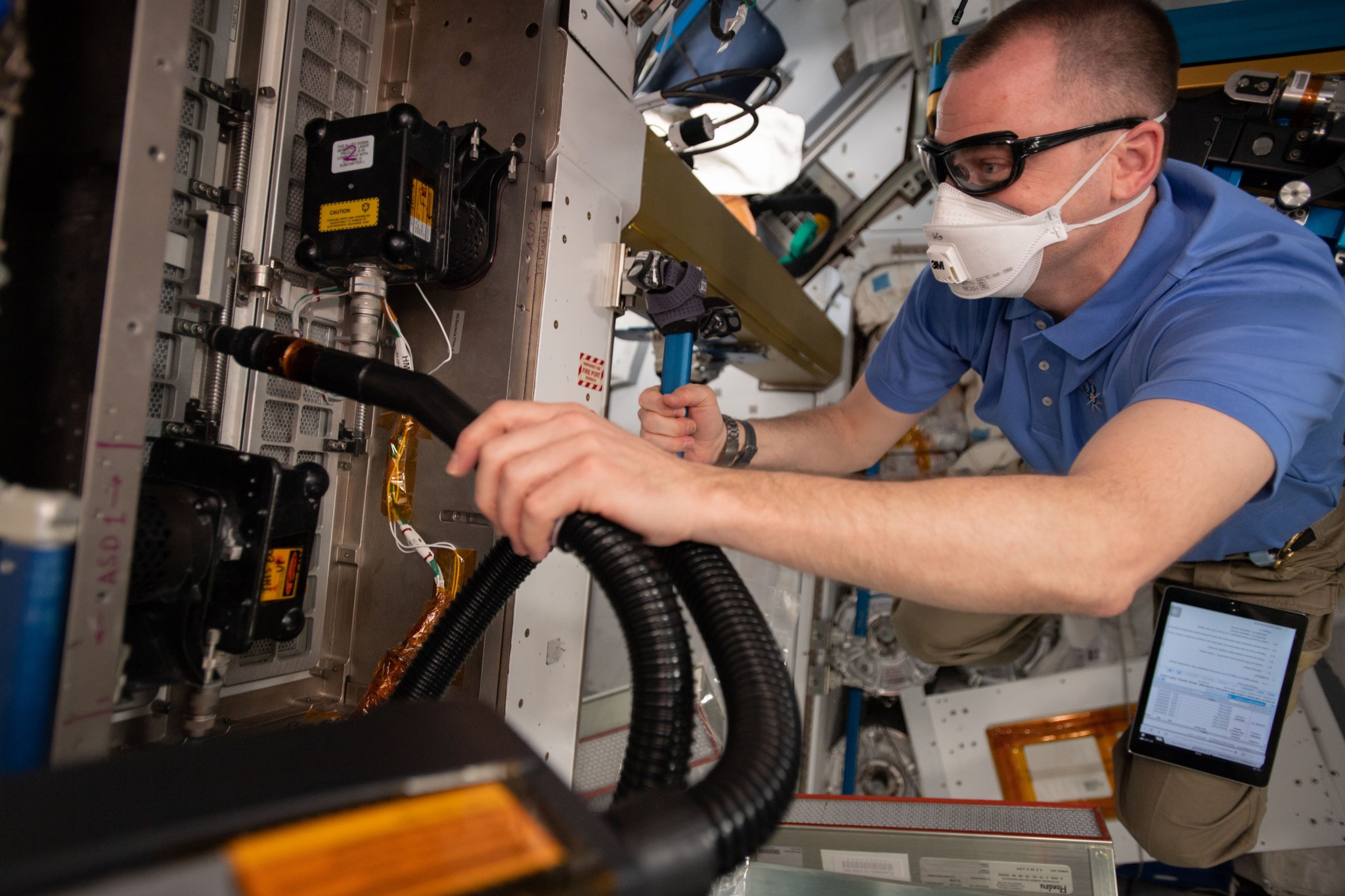 Expedition 59 flight engineer and NASA astronaut Nick Hague replaces filters inside the International Space Station