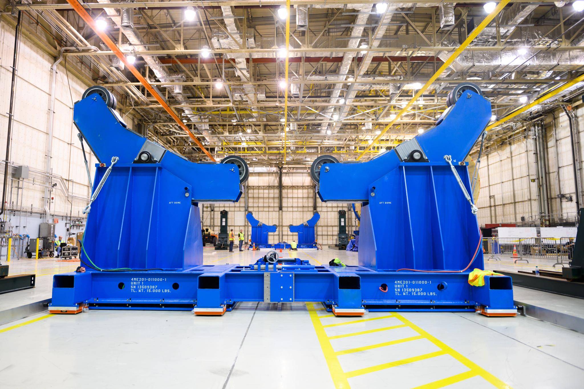 Technicians prepare the passive roller tool built by Futuramic to transport the massive liquid hydrogen fuel tank.