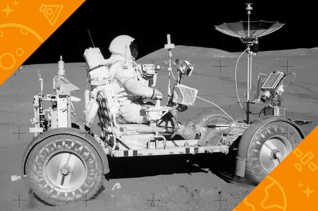 Black and white photo of Apollo 15 LRV driven by Commander Dave Scott on the surface of the moon