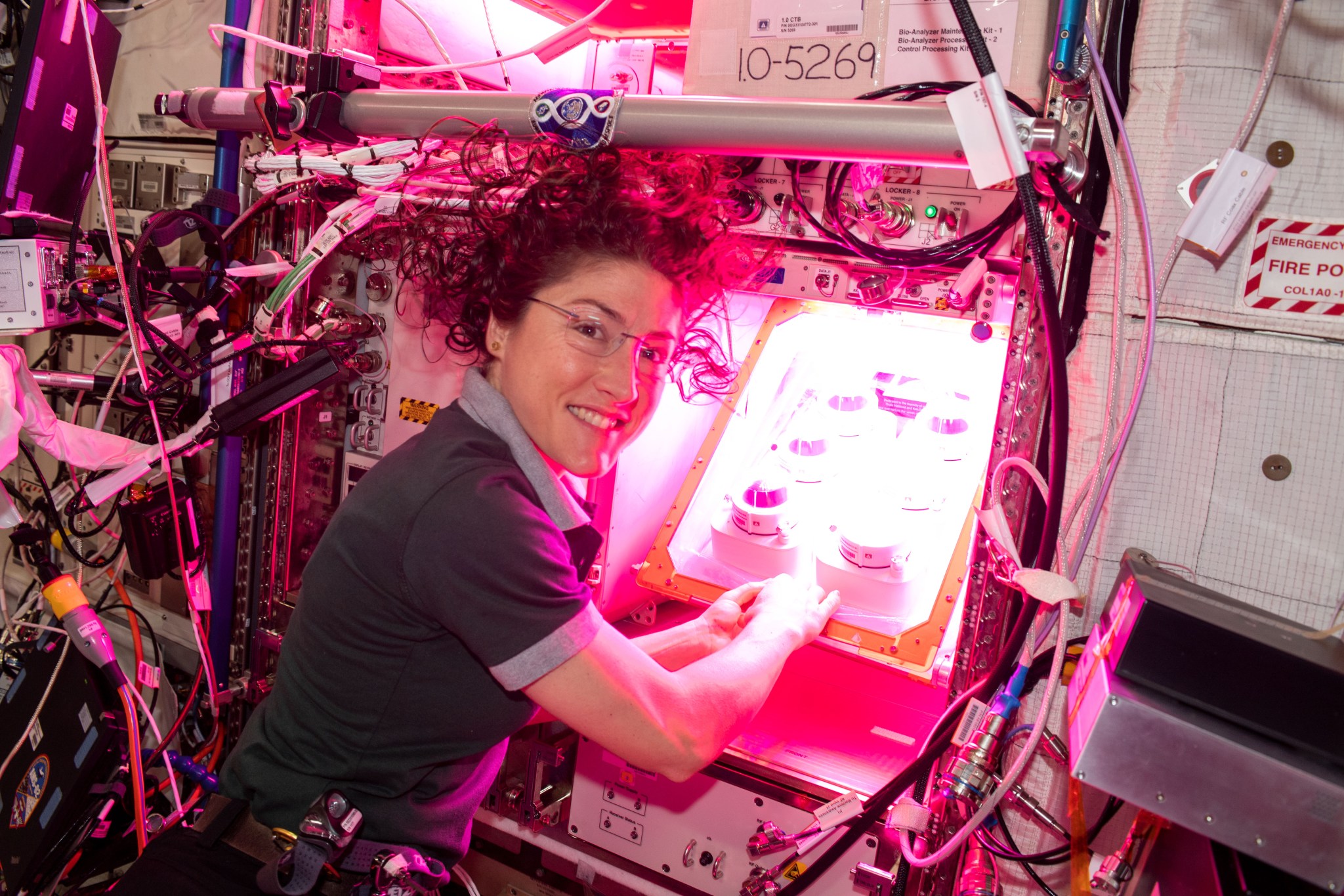 NASA astronaut Christina Koch initiates the Veg-PONDS-02 experiment by filling the upper reservoir on April 25, 2019.
