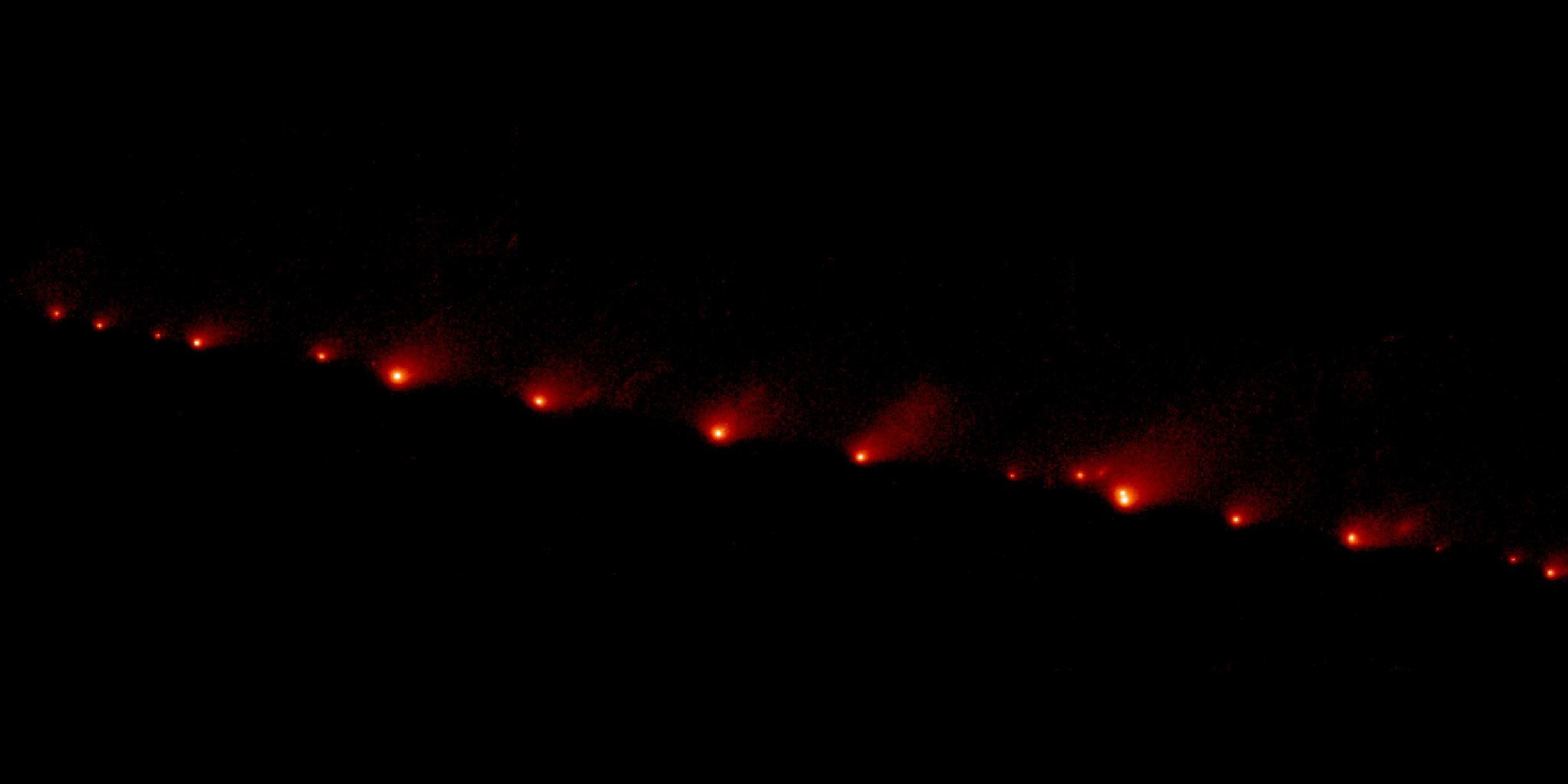 streak of red glowing objects on black