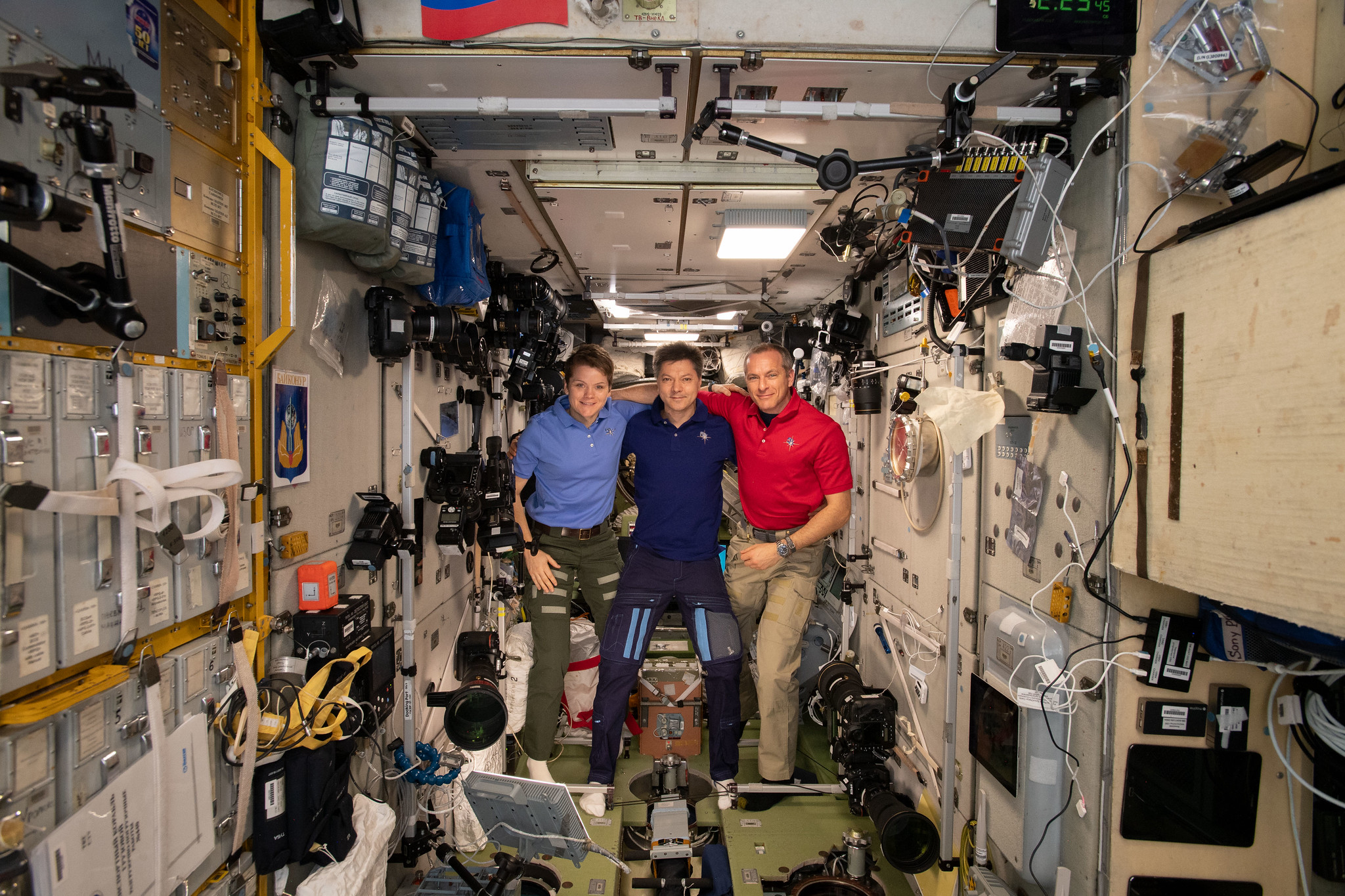 Expedition 58/59 crew members gather inside the Zvezda service module for a crew portrait.