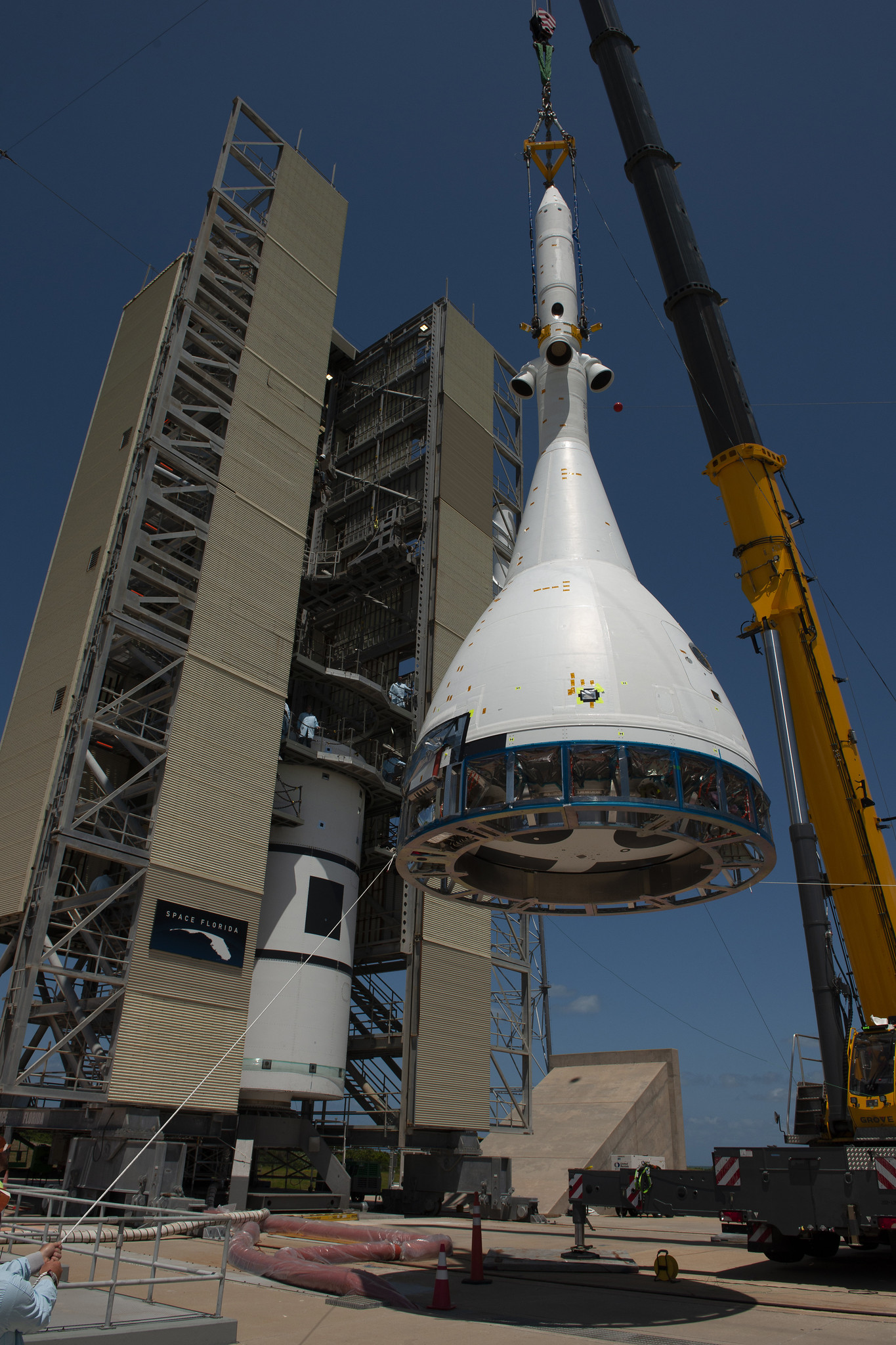 The Orion test article for Ascent Abort-2 is hoisted by crane at Space Launch Complex 46 at CCAFS in Florida.
