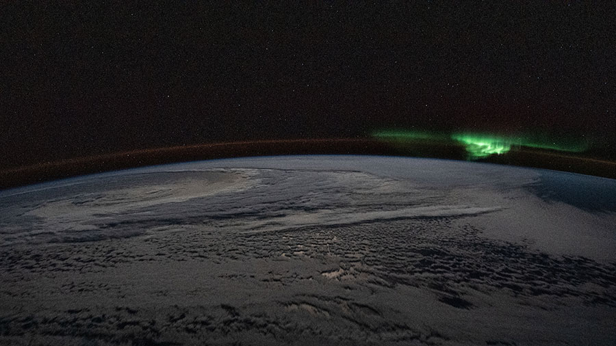 The atmospheric glow and a wispy aurora australis