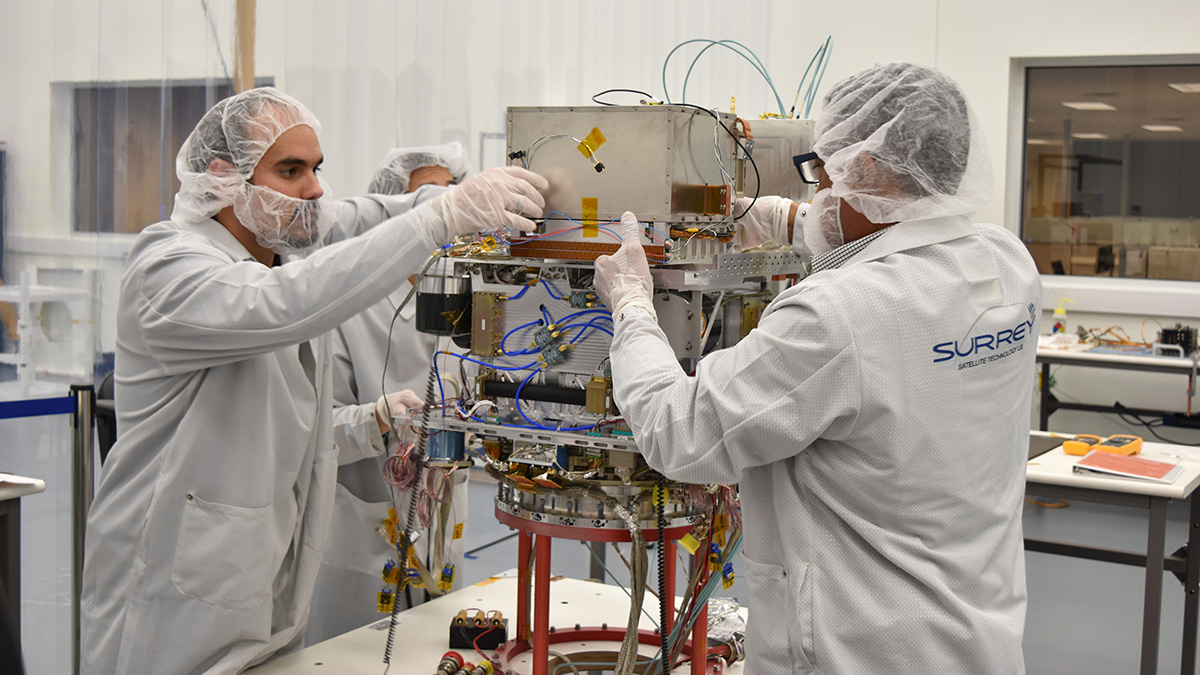 Technicians working on the atomic clock