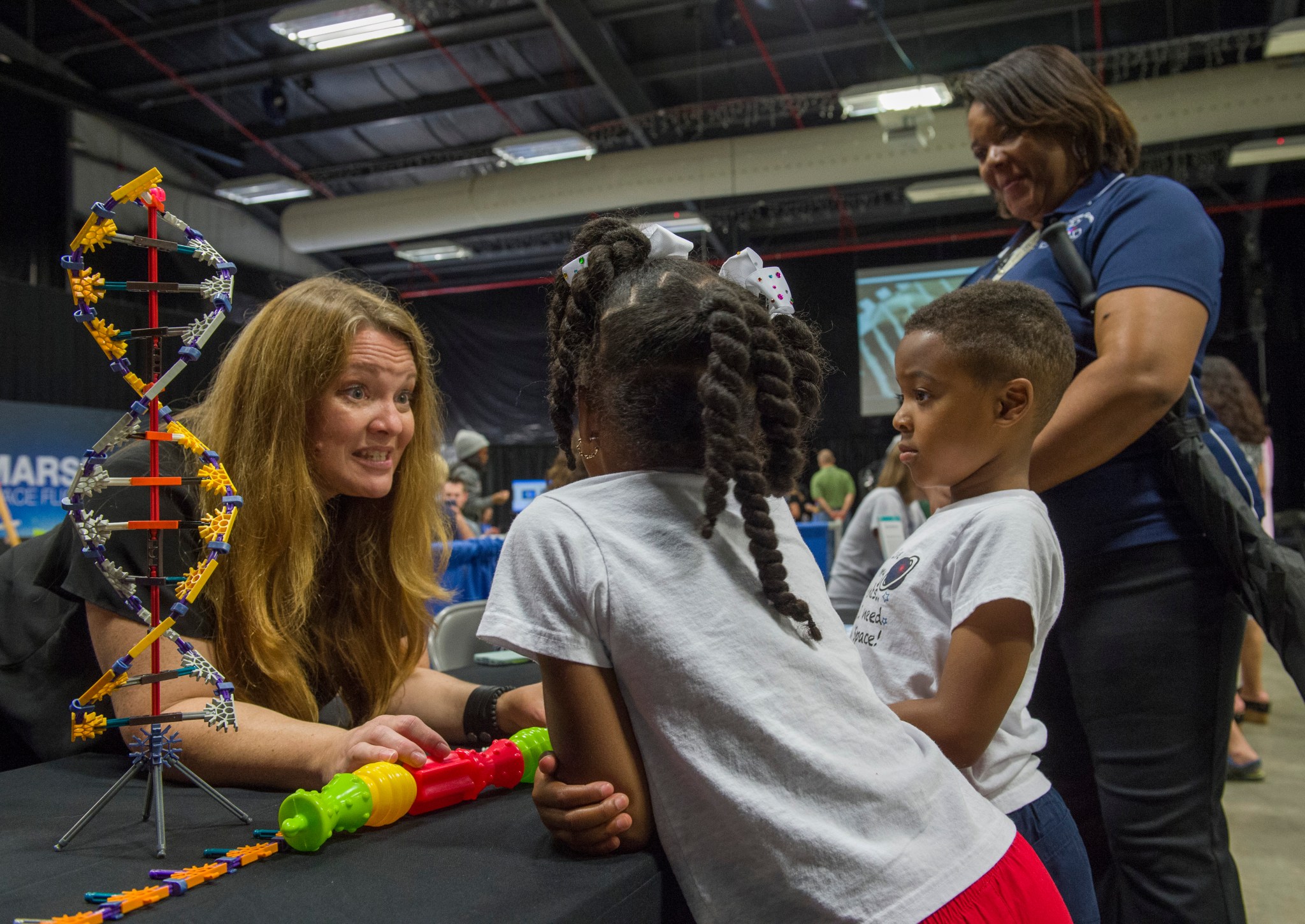 Ava Schaefer, left, talks to 6-year-olds Baelyn and Braelen Green.