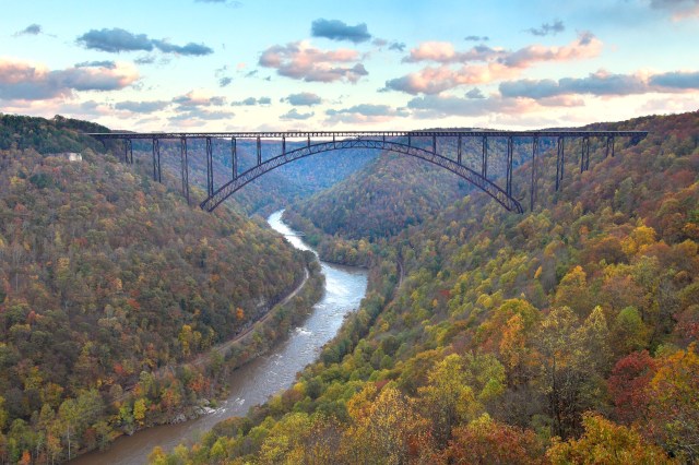 Photo of a train bridge with fall foliage