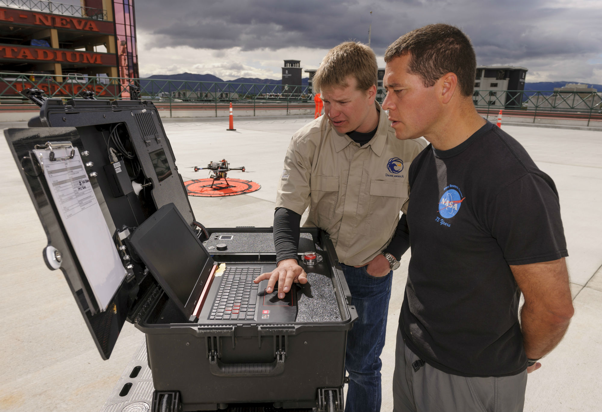 A NASA researcher monitors the progress of a test in the urban landscape Reno, Nevada, of a drone traffic management system.