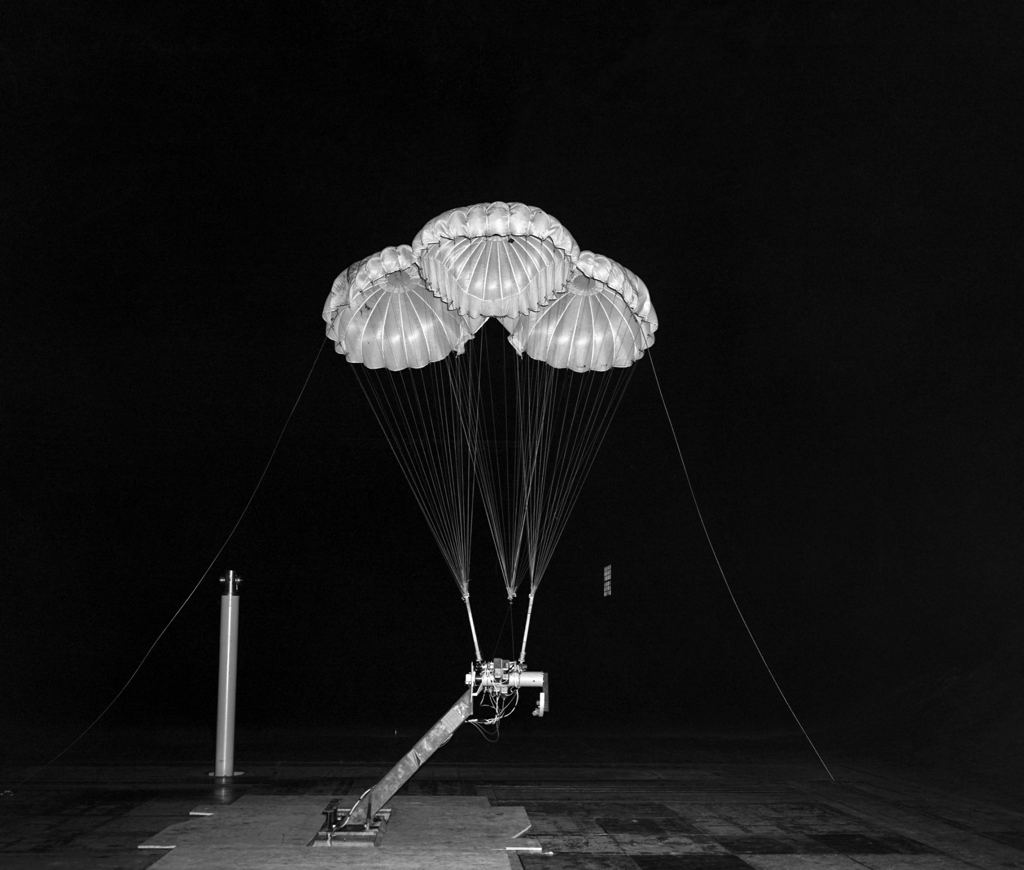 Parachutes from the Apollo era open for testing in a wind tunnel.