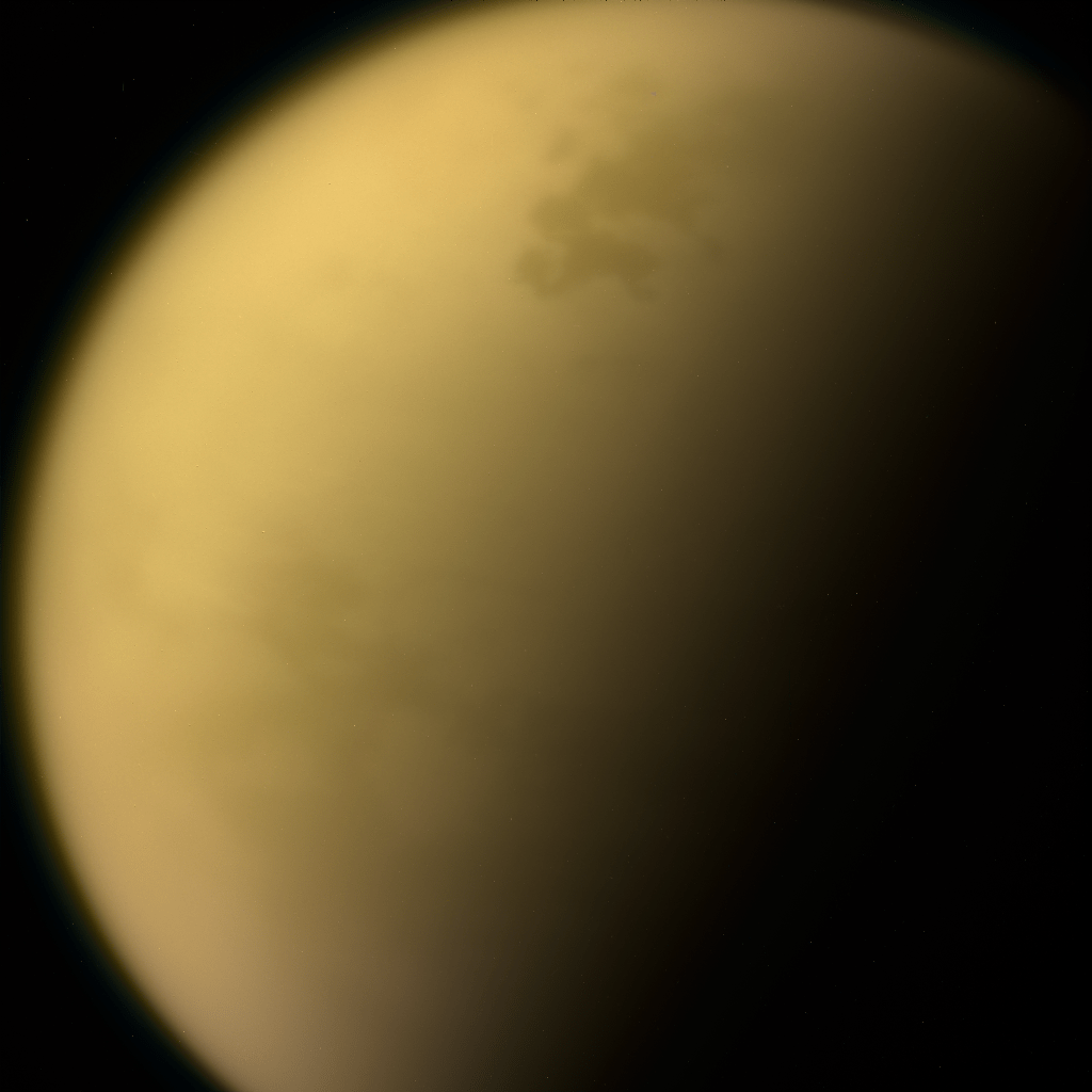 Hazy layers of hydrocarbons enshroud Saturn’s moon, Titan. On its surface, methane rivers flow into tar-edged seas.