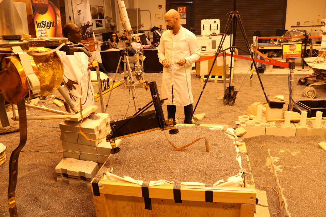 Engineers in a Mars-like test area at NASA's Jet Propulsion Laboratory