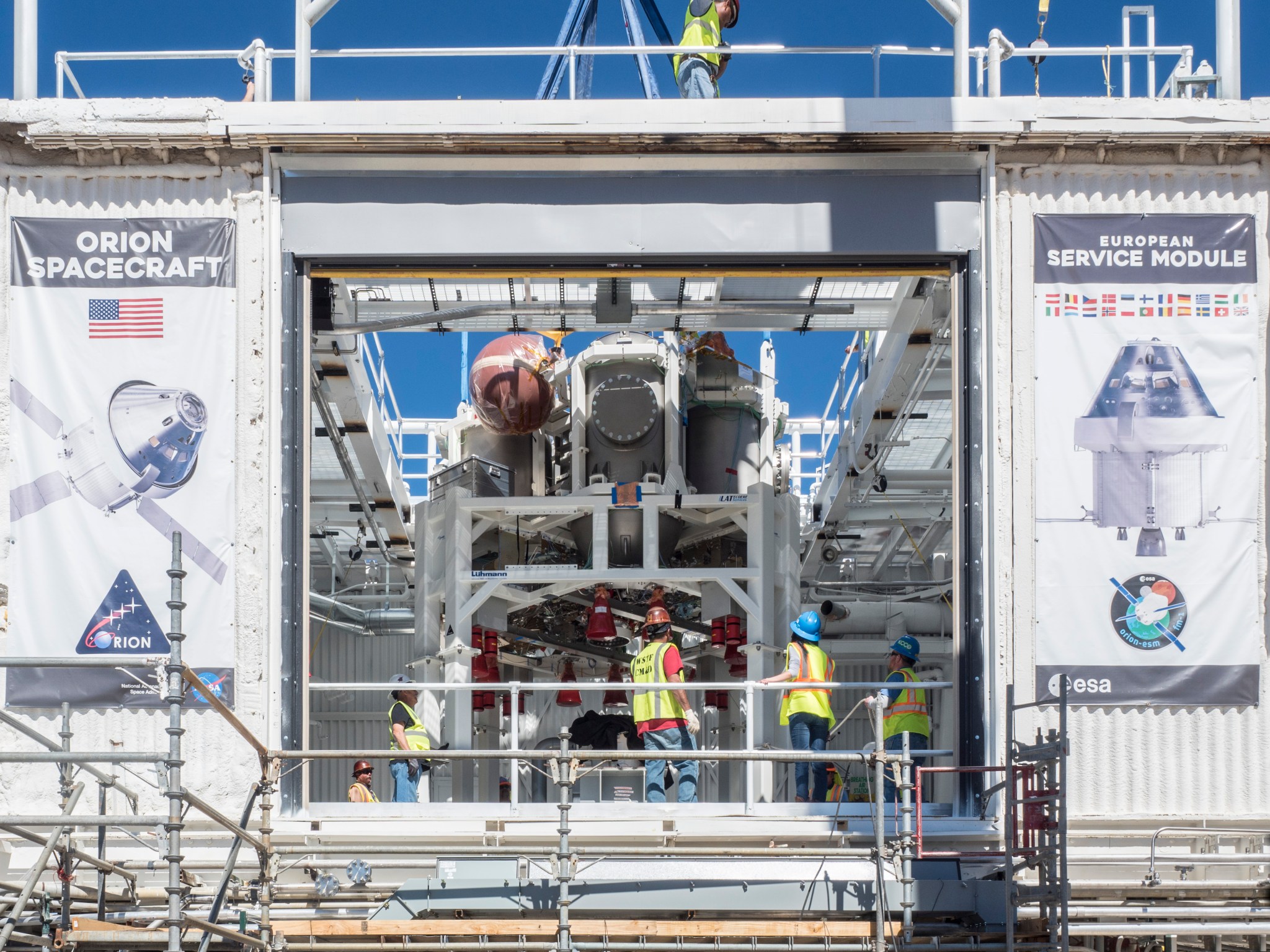 Engineers perform work ahead of testing of the Orion propulsion system