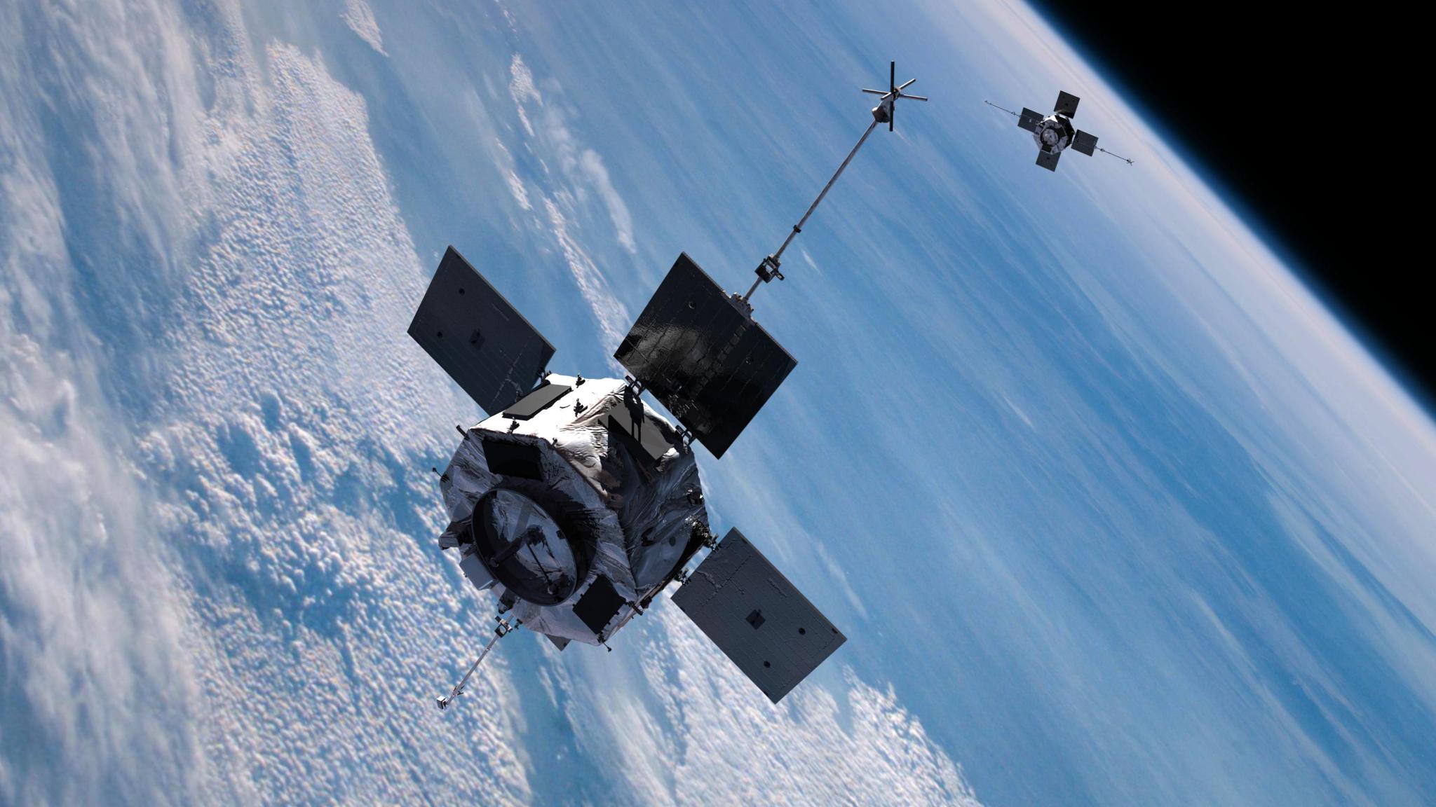 The Van Allen Probes, which look like two silver boxes with four squat solar panels and two antennae. They are soaring in space over the light blue and cloudy limb of Earth.