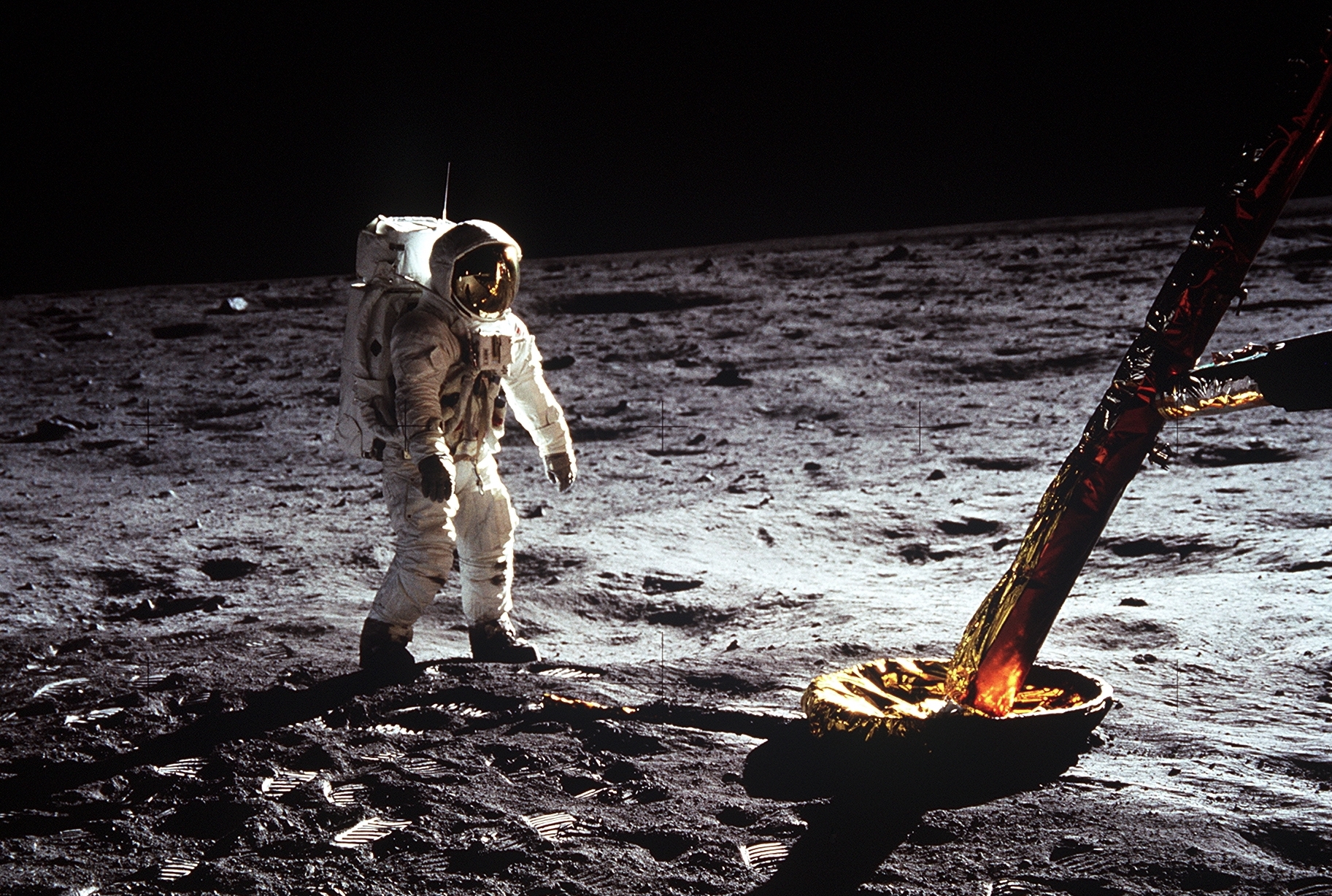 Astronaut Buzz Aldrin walks on the surface of the Moon near a leg of the lunar module during Apollo 11. 