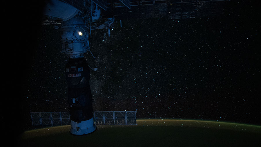 Earth's luminous atmospheric glow back-dropped by the tranquil Milky Way
