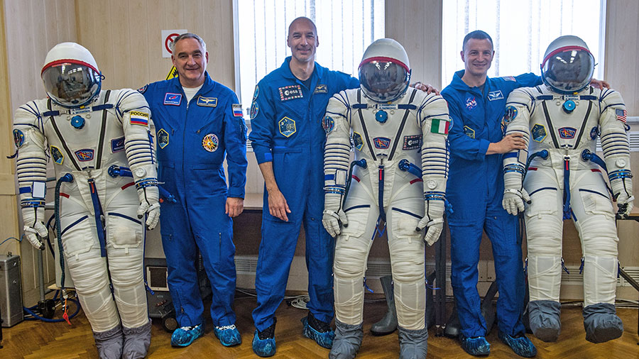 Expedition 60 crewmembers pose with their Sokol launch and entry suits