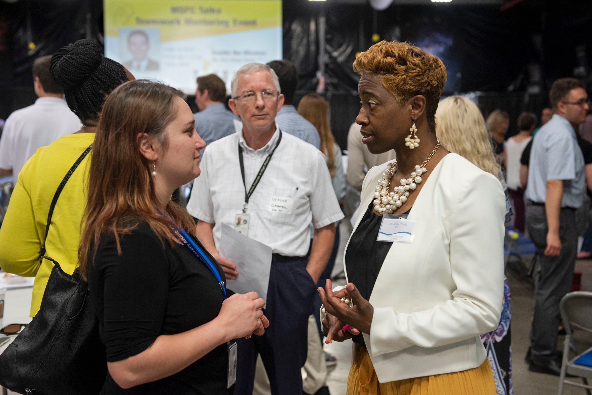 Ruth Jones, right, chats with Diana Zorzon, left, and Wayne Gamwell during a networking session between speaker presentations.