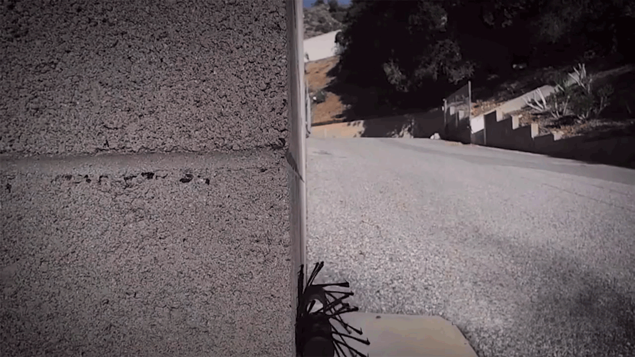A tiny climbing robot rolls up a wall
