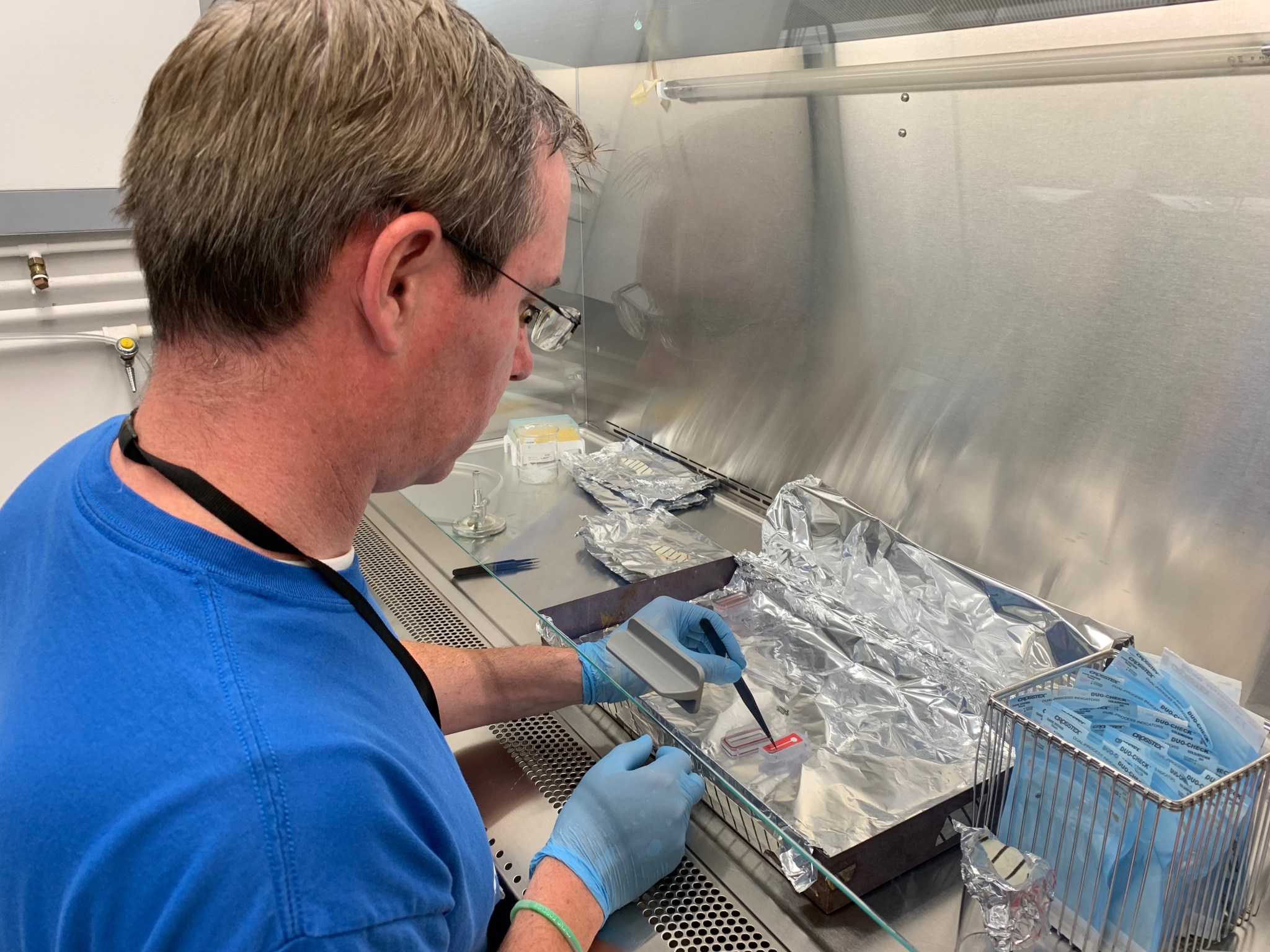 Principal Investigator, Dr. Craig Everroad, loading Bacillus subtilis samples into the hardware.  