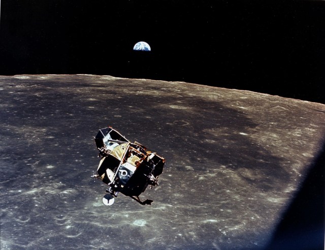 Lunar module over Moon with Earth in background.