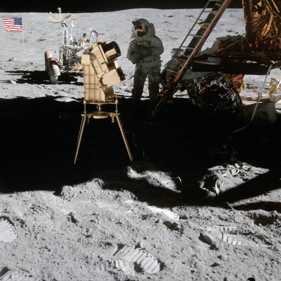 Apollo 16 astronaut John Young uses a moon-based telescope