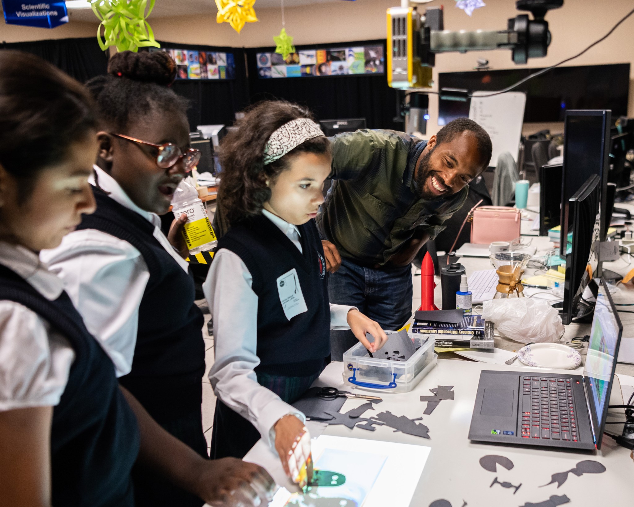 Calvin Robinson uses a wind tunnel demonstration to show students how air moves around objects