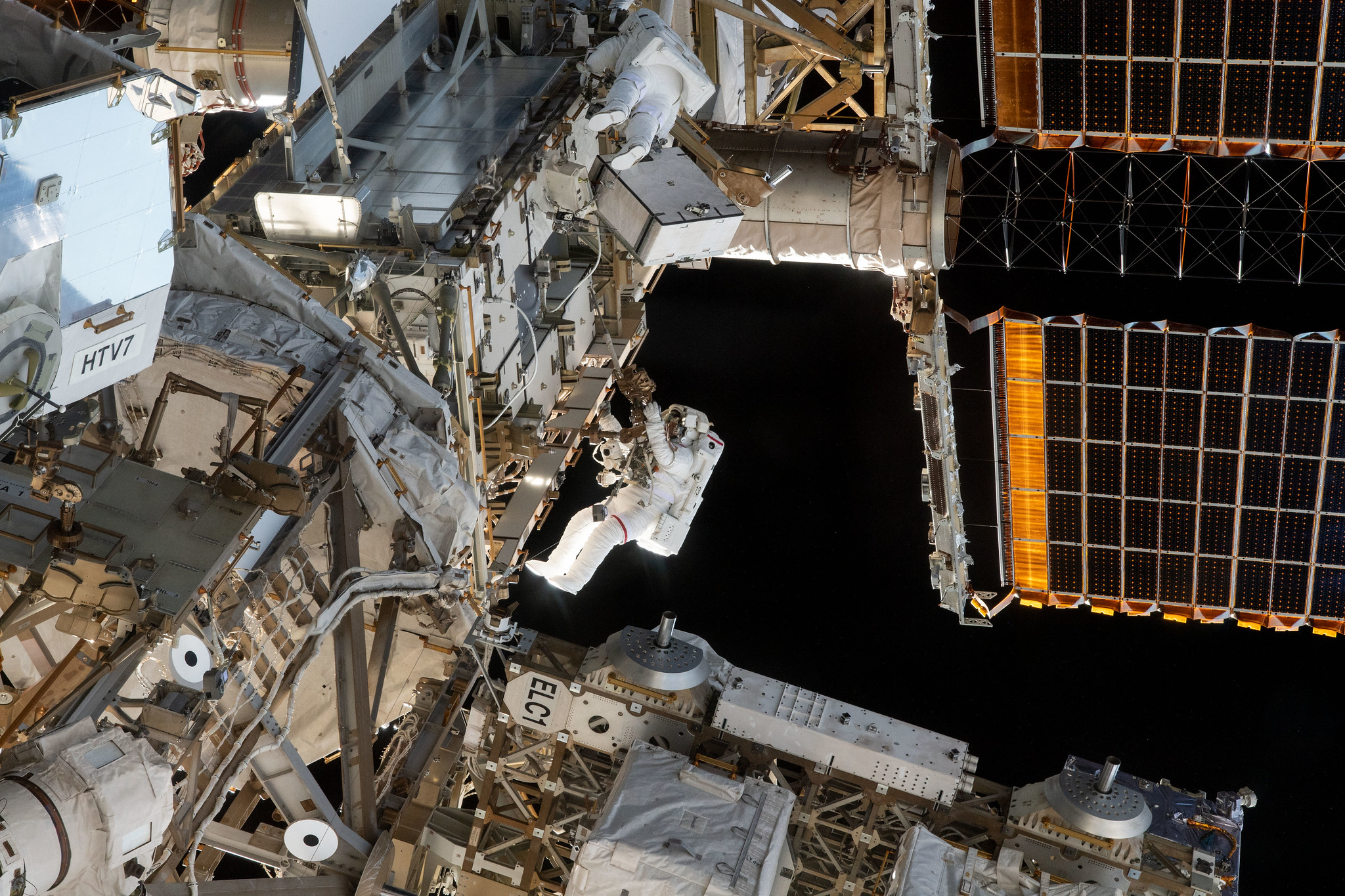 NASA astronauts Christina Koch (center top) and Nick Hague (suit with red stripe on legs) conduct a spacewalk March 29 