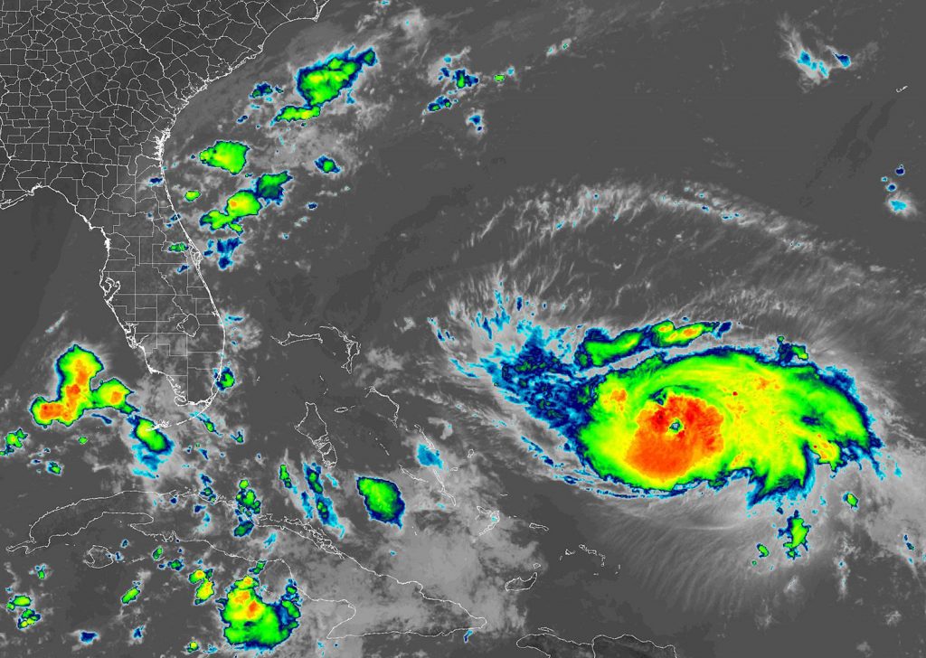 Hurricane Dorian, right, as viewed from the GOES-East satellite on Friday, Aug. 30, 2019.