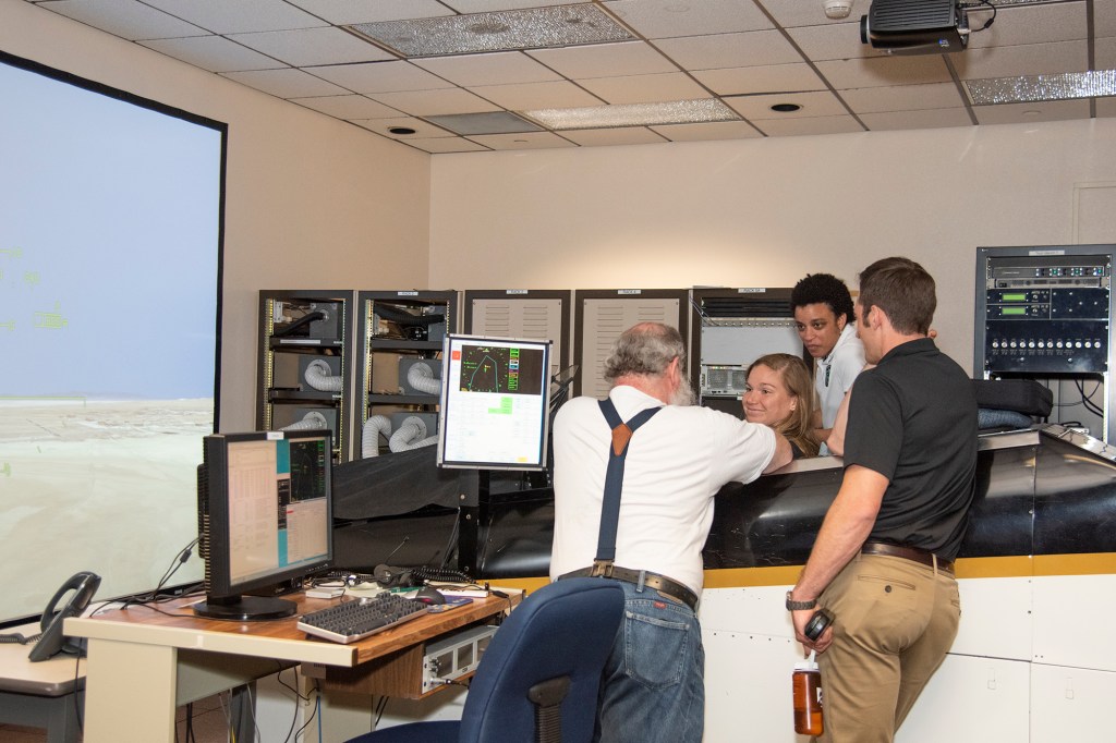 NASA's 2017 astronaut candidates practice flying in an F-18 aircraft cockpit simulator at AFRC.