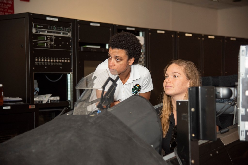 NASA's 2017 astronaut candidates practice flying in an F-18 aircraft cockpit simulator at AFRC.
