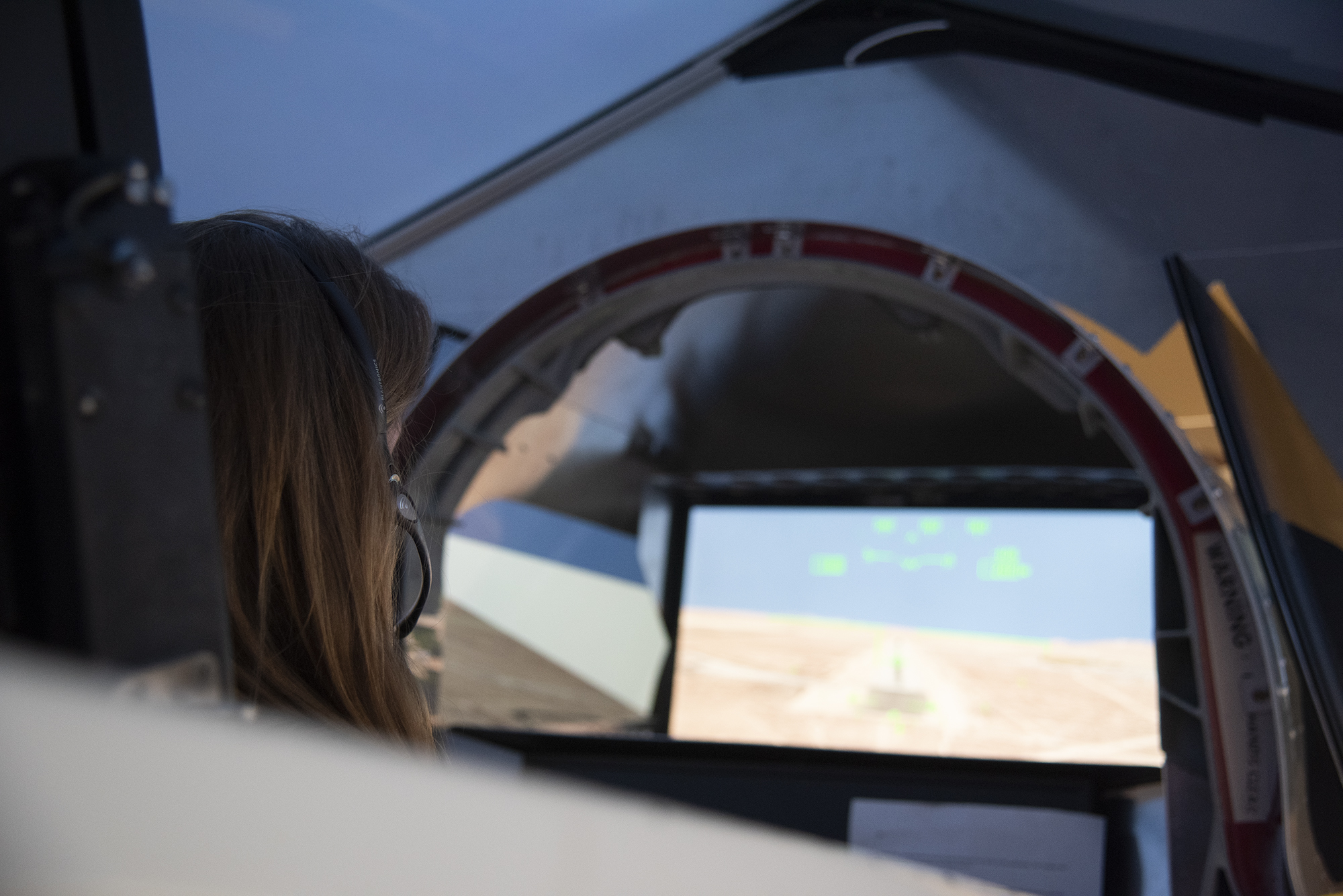 NASA's 2017 astronaut candidate Kayla Barron practices flying in an X-59 QueSST simulator at Armstrong Flight Research Center, i