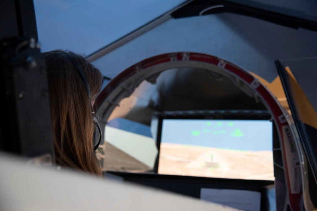 NASA's 2017 astronaut candidate Kayla Barron practices flying in an X-59 QueSST simulator at Armstrong Flight Research Center, i