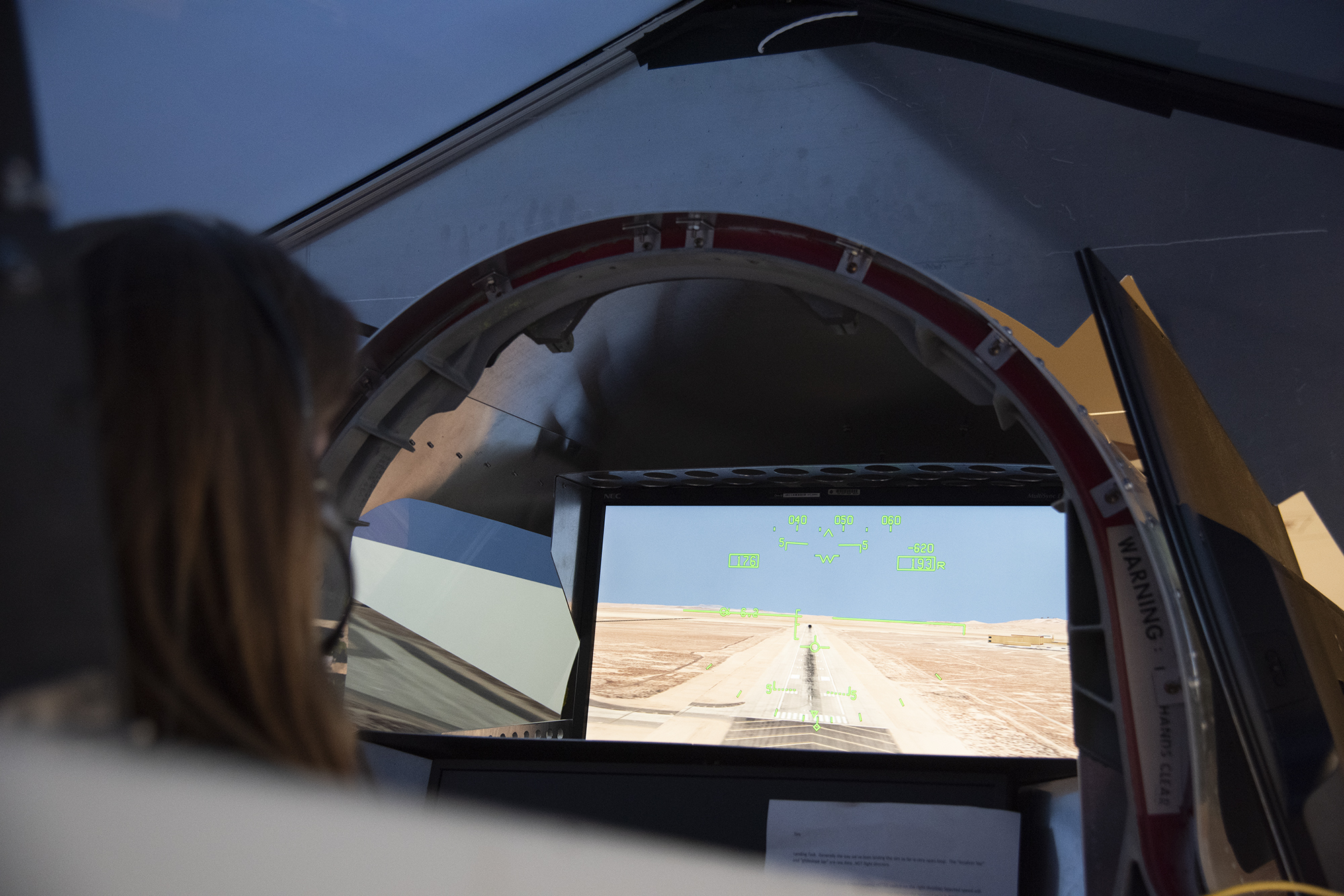 NASA's 2017 astronaut candidate Kayla Barron practices flying in an X-59 QueSST simulator at Armstrong Flight Research Center,
