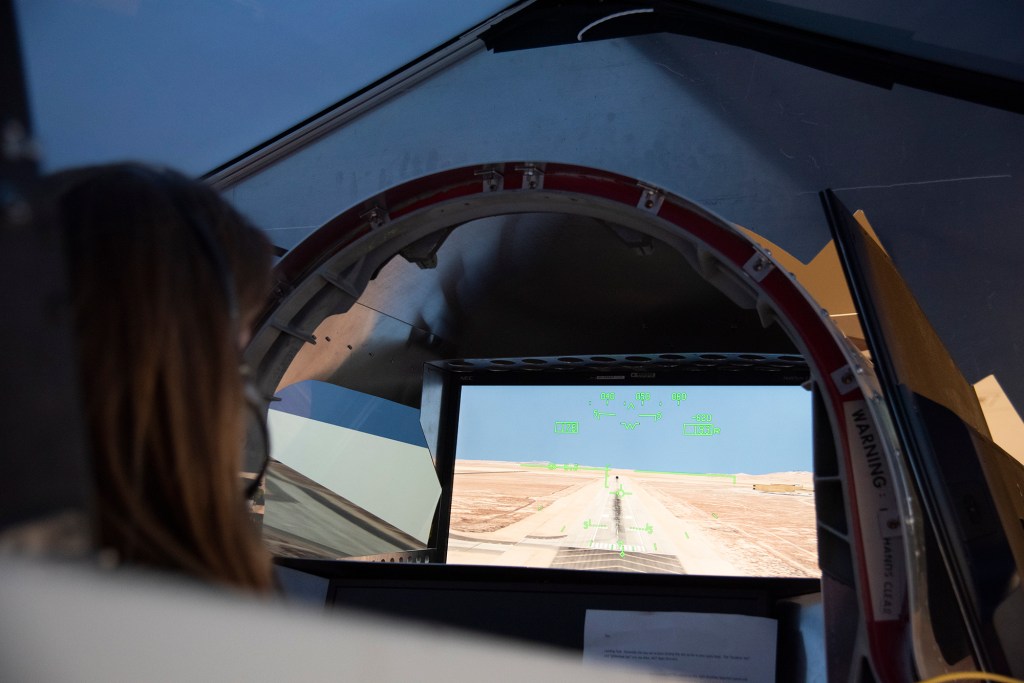 NASA's 2017 astronaut candidate Kayla Barron practices flying in an X-59 QueSST simulator at Armstrong Flight Research Center,